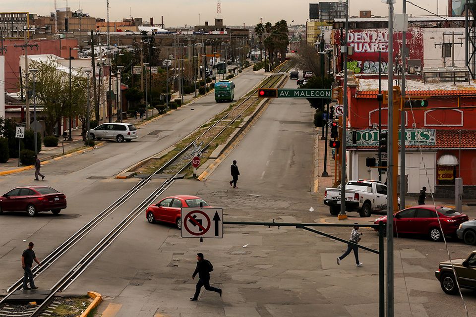 Juárez — the largest city in Chihuahua, Mexico — is home to around 1.3 million residents, according to 2010 data from Mexico’s National Institute of Statistics and Geography. Pedestrians cross the street in downtown Juárez. Image by Erika Schultz. Mexico, 2020.