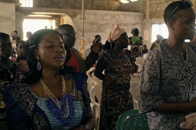 Every Sunday, Mabel Musa attends church praying for her patients to stop dying from Ebola. Image by DOCDAYS Productions/Carl Gierstorfer. Liberia, 2015.