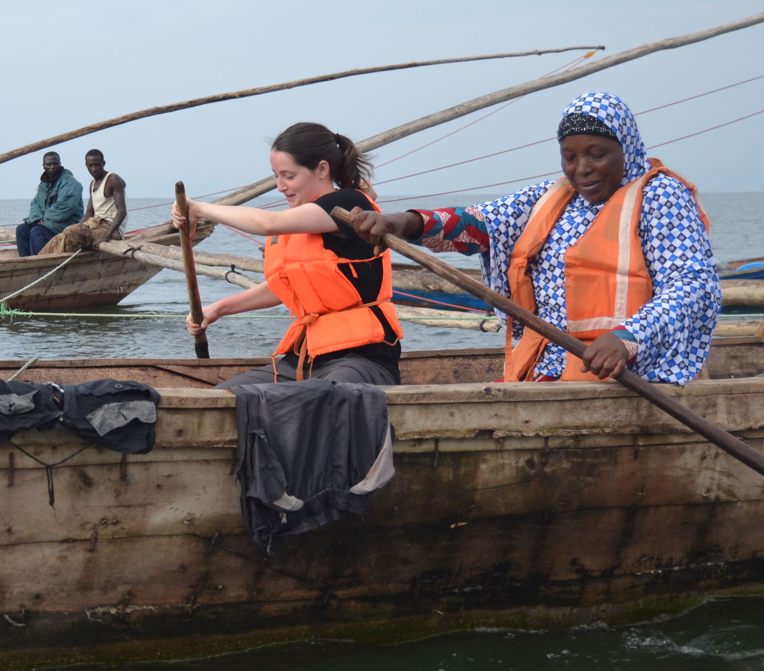 Cammie Behnke and Sauda Mukamusoni row a boat back to the shore of Lake Kivu. Image by Theo Ndagijimana. Rwanda, 2018.