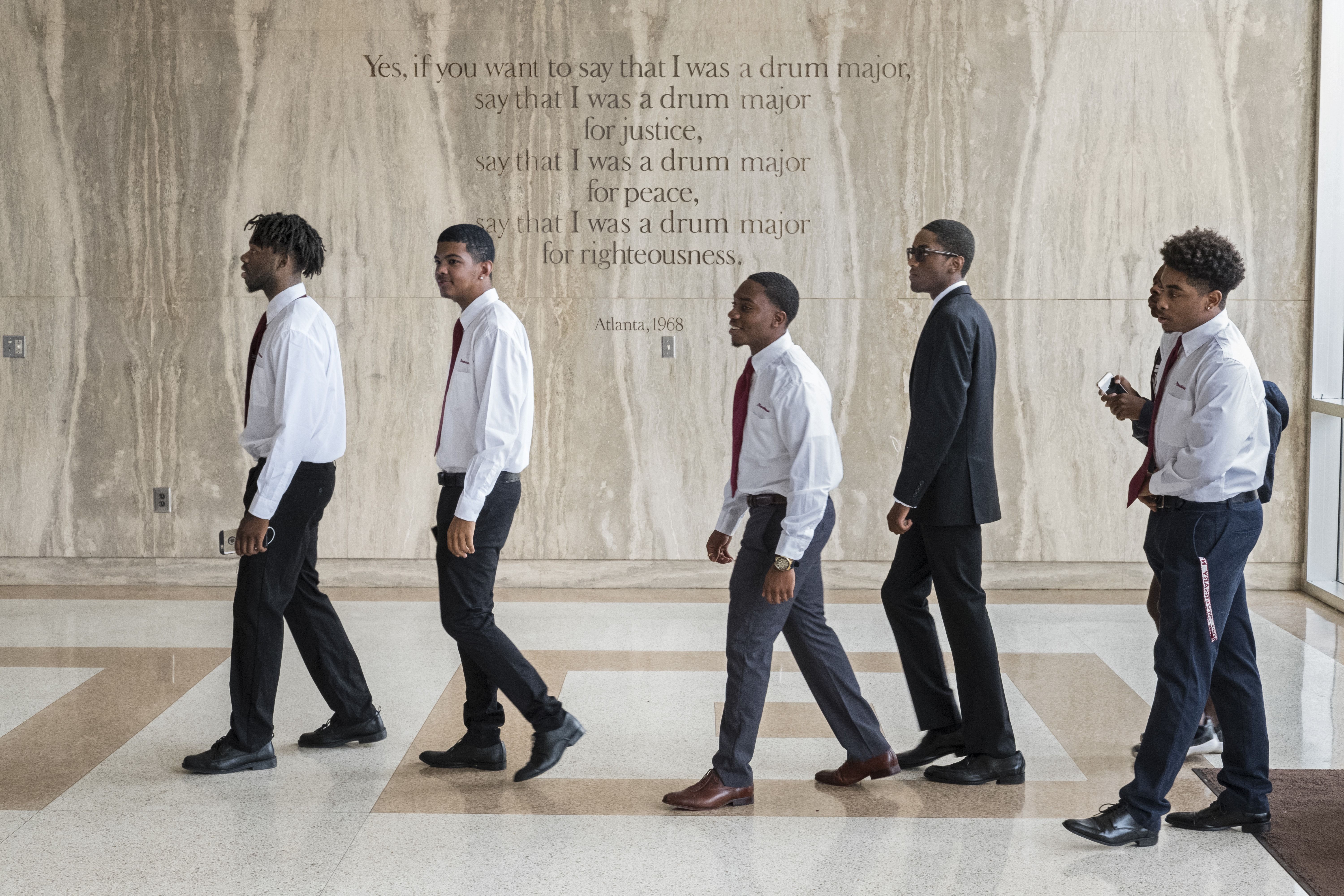 Freshmen enter the Morehouse chapel named for Martin Luther King, Jr., whose words are etched on the wall. The weekly, required Crown Forum assembly introduces leaders who address issues of the day. The all-male college aims to develop disciplined men who will lead lives of scholarship and service. Image by Radcliffe "Ruddy" Roye. United States, 2017.
