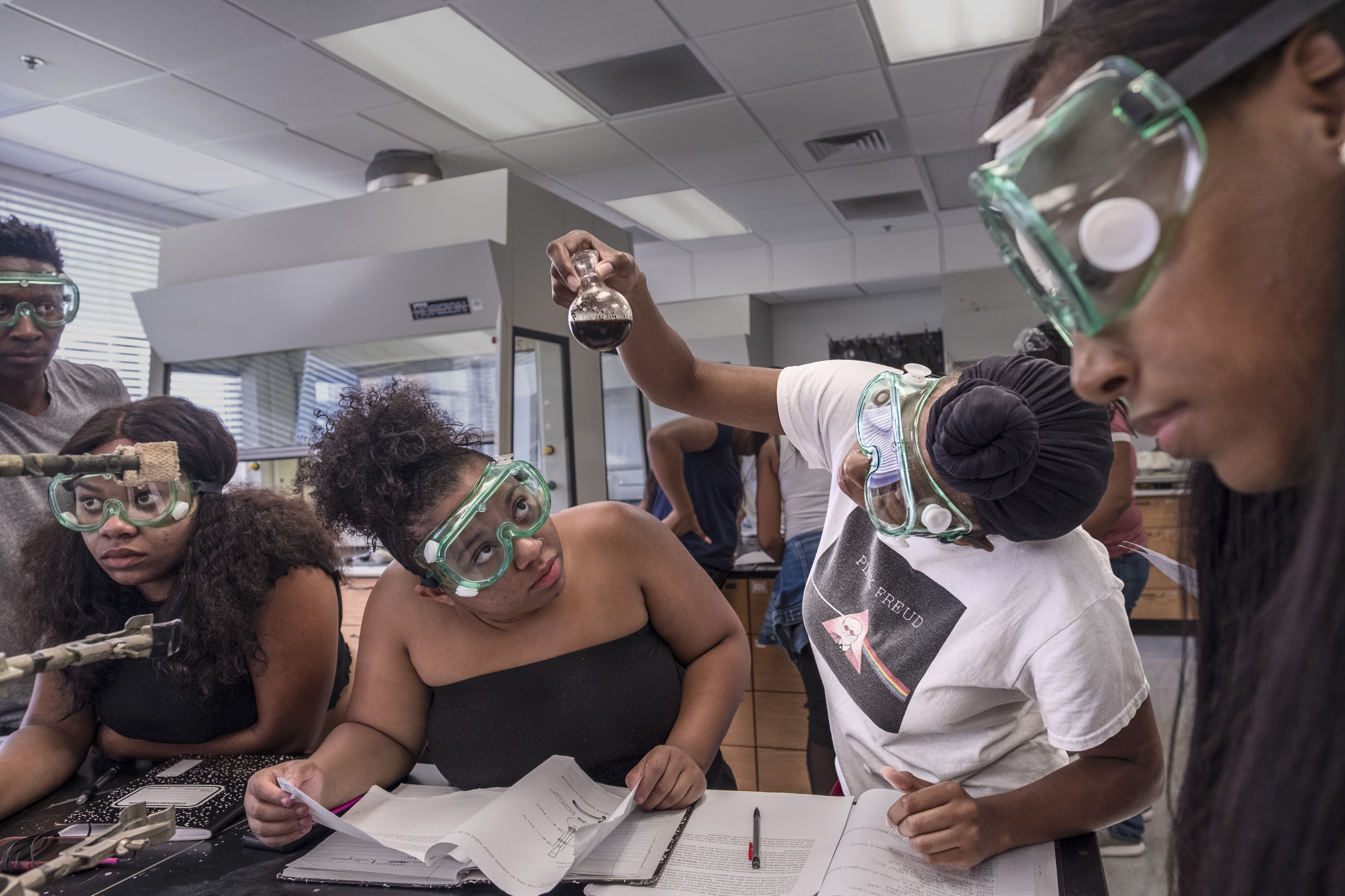 Students at Clark Atlanta University work on a chemistry lesson. Historically black colleges account for nearly half of the top 50 schools that produce black students who go on to receive graduate degrees in science, technology, engineering, and math. Image by Nina Robinson. United States, 2017.