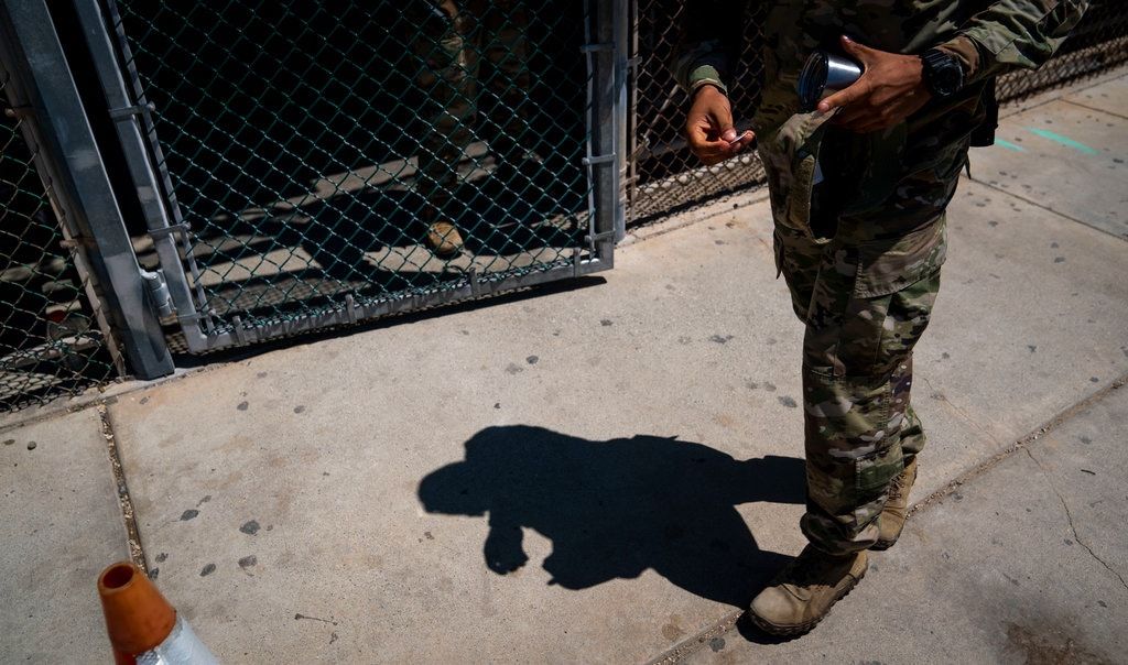 A military police officer leaving the Camp 6 detention center at Guantánamo Bay in April. The most secretive detention area, Camp 7, is off limits to the news media. Image by Doug Mills/The New York Times. Cuba, 2020.