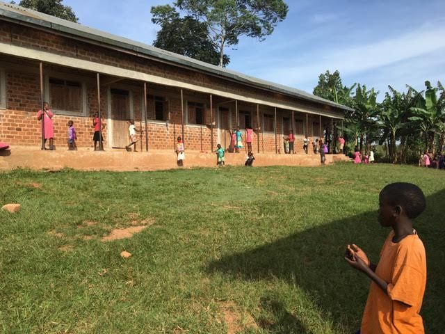 Students play in the school yard of a Building Tomorrow School as they wait to receive their report cards. Image by Brandon Posner. Uganda, 2016.