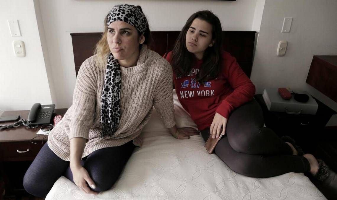 Lisset López Rodríguez (left) and her daughter Camila Guzmán López in their tiny hotel room in Bogota, Colombia as they wait for an interview date at the U.S. Embassy in Bogota. Since the reduction of staff at the U.S. Embassy in Havana because of health attacks against diplomats, Cubans that were in the process of getting permanent visas for their family members to travel to the United States now have to go to Bogota, Colombia to complete the process. Image by José A. Iglesias. Colombia, 2017. 