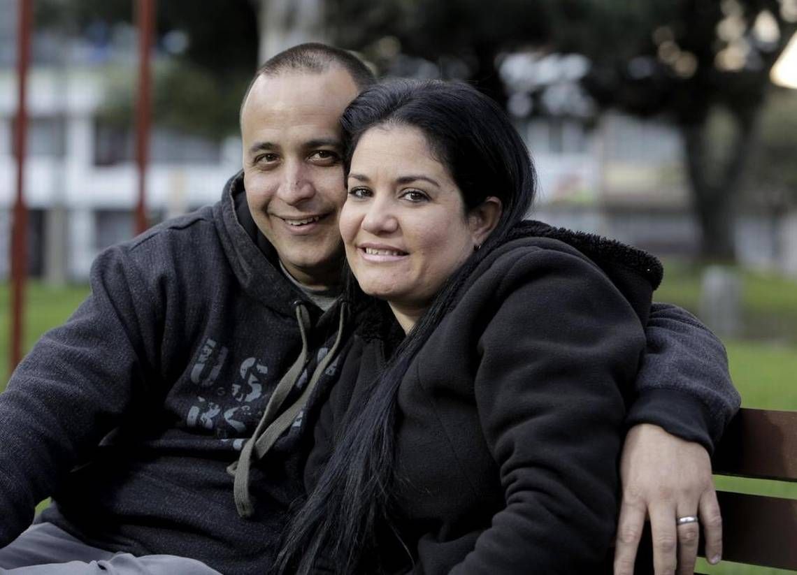 Yackmar Domínguez Santos and his wife Malena Fernández Gutiérrez pose for a photo in a park in Bogota, Colombia, as they wait for interview date at the U.S. Embassy in Bogota that would hopefully allow his wife Malena and their son to join him in the United States. Yackmar flew in to Bogota from Miami to be with his wife and son during the process. Image by José A. Iglesias. Colombia, 2017.
