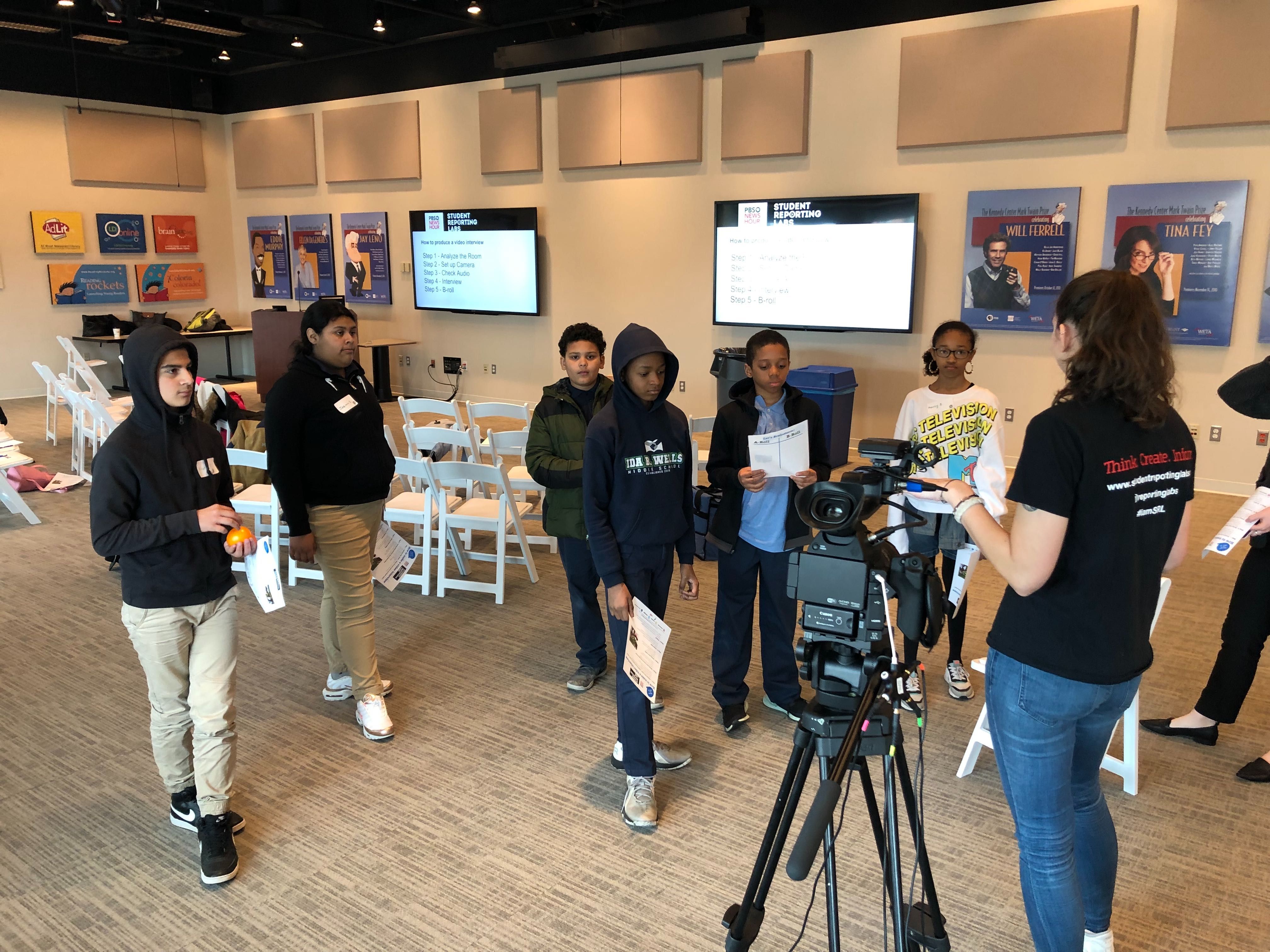 Becky Wandel, production assistant with PBS NewsHour Student Reporting Labs, shows the students how to arrange an on-camera interview. Image by Libby Moeller. United States, 2020.