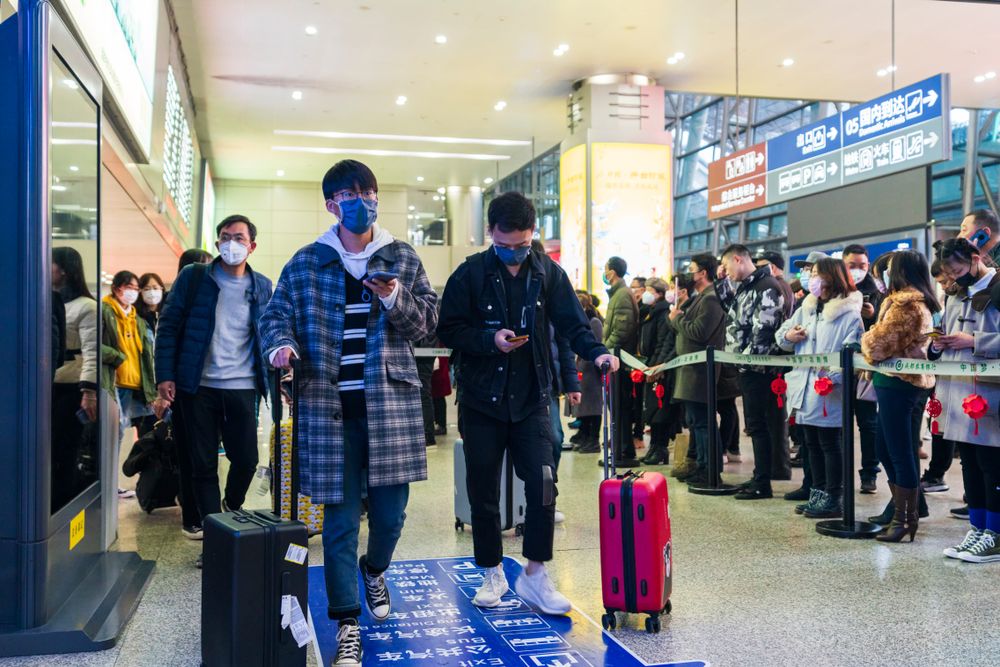 Chengdu, Sichuan, China: Travelers wear masks at the airport to prevent infection from coronavirus. Image by B.Zhou / Shutterstock. China, 2020.