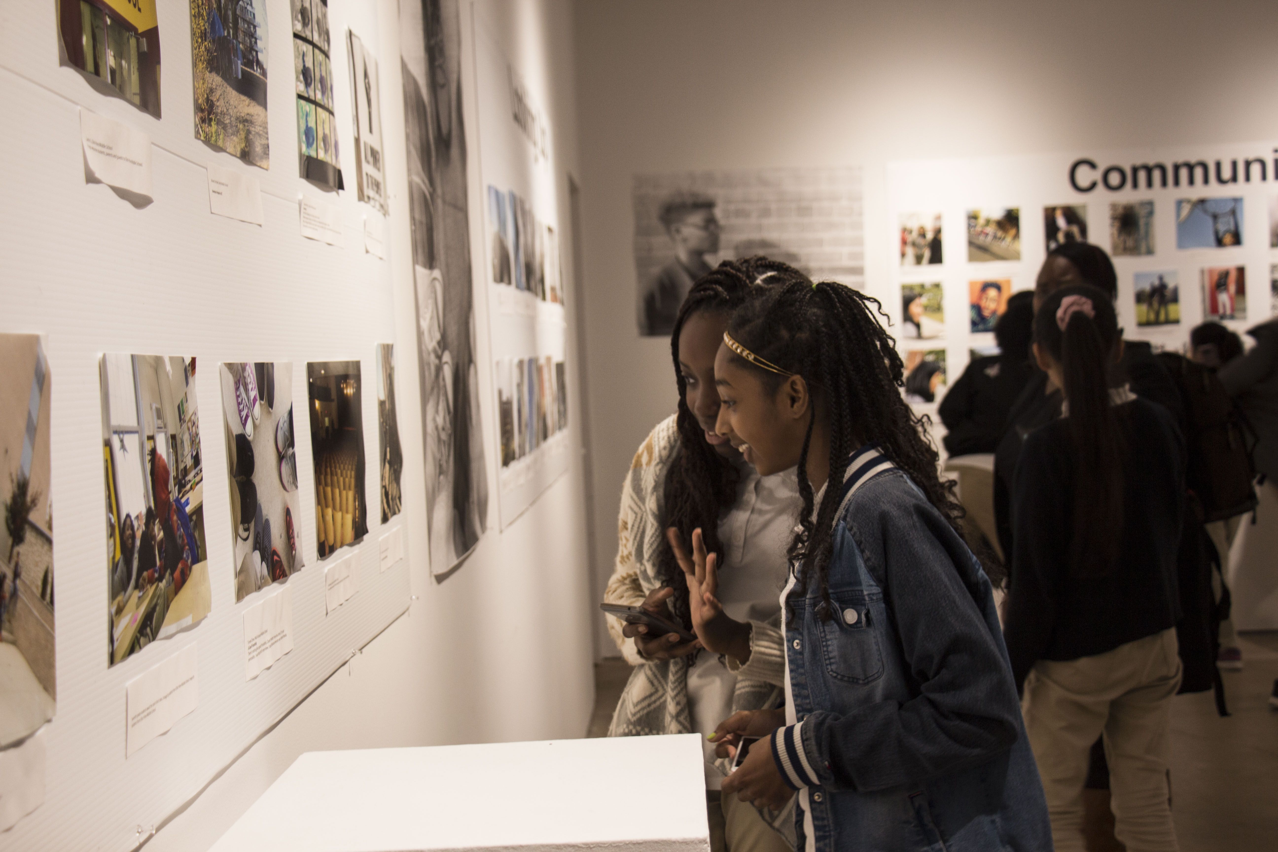 Students observe the Everyday DC Photography Exhibition to learn about photographing everyday life in Washington, DC. Image by Ifath Sayed. United States, 2017.