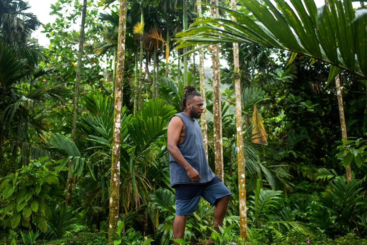 Philip Manakako climbs through the forest near his home village of Marasa. He was instrumental in pressuring Gallego, the logging company denuding the forest above his home, to leave. Image by Monique Jaques. Solomon Islands, 2020.
