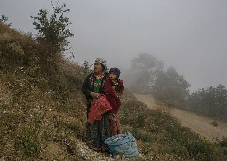 Outside the small village of Chicua, in the western highlands, in an area affected by extreme-weather events, Ilda Gonzales looks after her daughter. Image by Mauricio Lima. Guatemala, 2019.