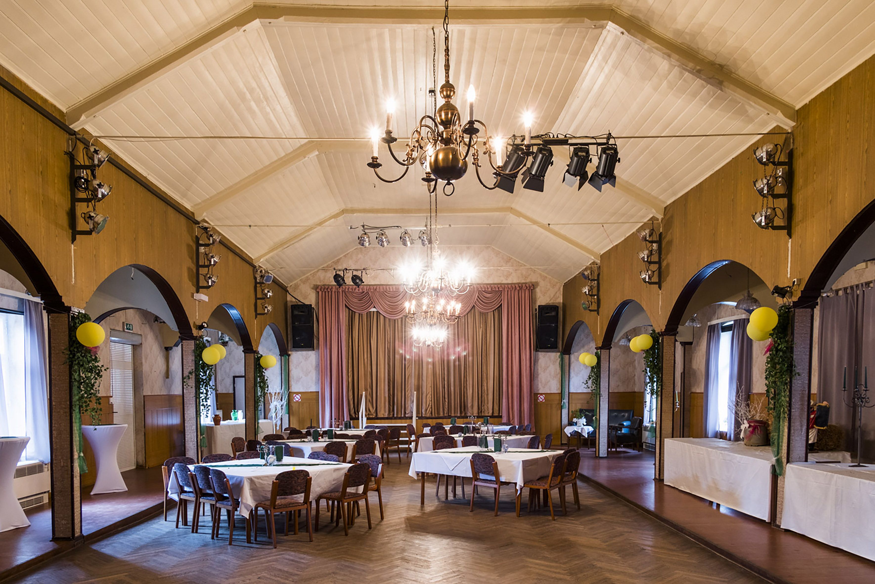 The East German-era banquet hall in Amt Neuhaus where more than 400 locals gathered in October 2015 to debate the arrival of refugees in Sumte. The hall was a chaotic scene, with journalists, far-right agitators, and many worried villagers who wanted to know what the arrivals would mean. Image by Valerie Schmidt. Germany, 2017.
