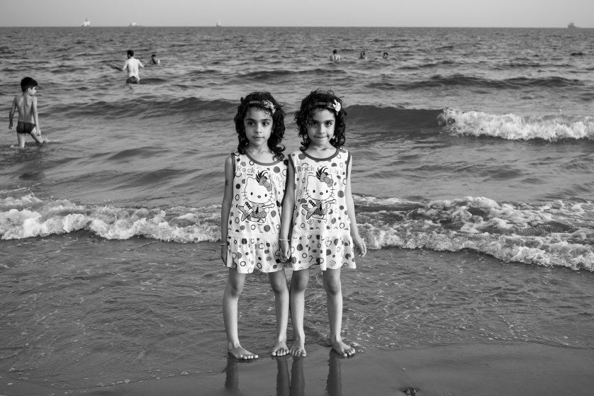 Twins escape from high temperatures at the seaside of Dayyer, Iran. According to scientists, by 2070, if worldwide emissions aren't sufficiently reduced, the Persian Gulf will experience heatwaves that will be impossible for many to survive. Image by Ako Salemi. Iran, 2016.