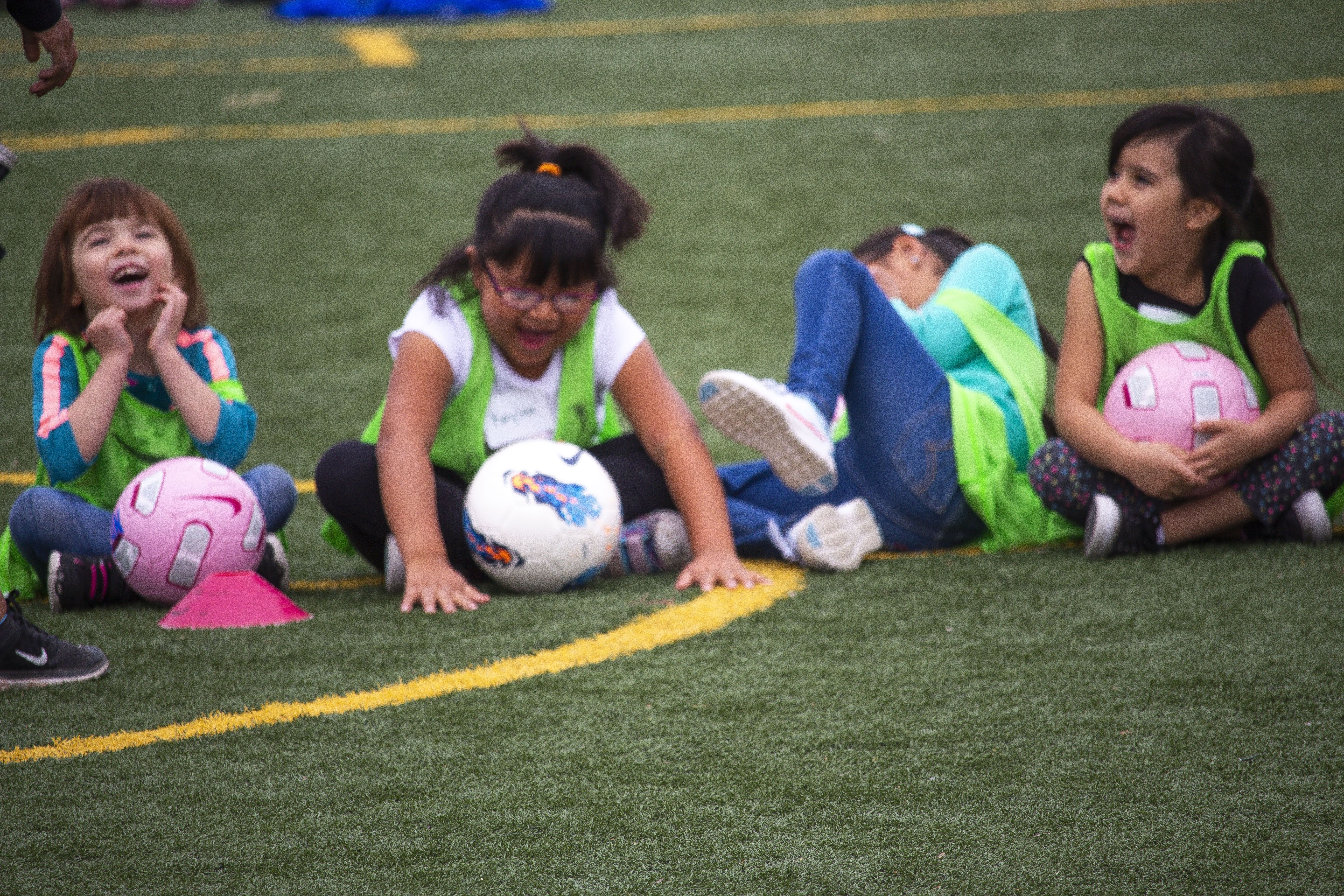 Students prepared for a scrimmage during the soccer clinic at Carroll Elementary School in Bernalillo, New Mexico. They laughed as their classmates were counted off into groups by fruit names like banana, strawberry, and apple. Image by Viridiana Vidales Coyt. United States, 2017.