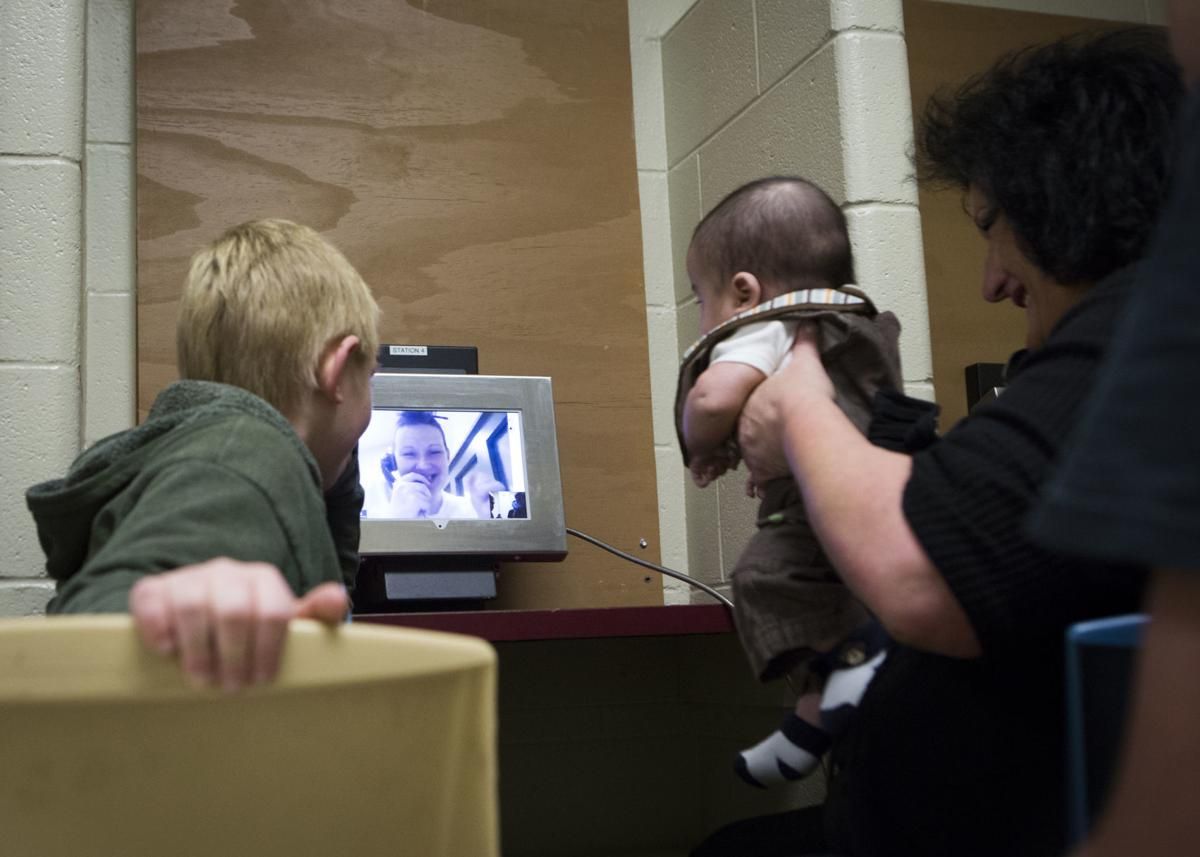 Tera Crowder speaks to her mother Deborah and two youngest sons James and Jadian through a video visitation at the Chesterfield County Jail in 2017. Image by Julia Rendleman. United States, 2017.
