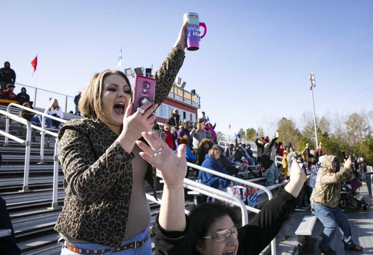 Tera Crowder and her mother Deborah cheer for James' football team in December 2019.  Image by Julia Rendleman. United States, 2019.