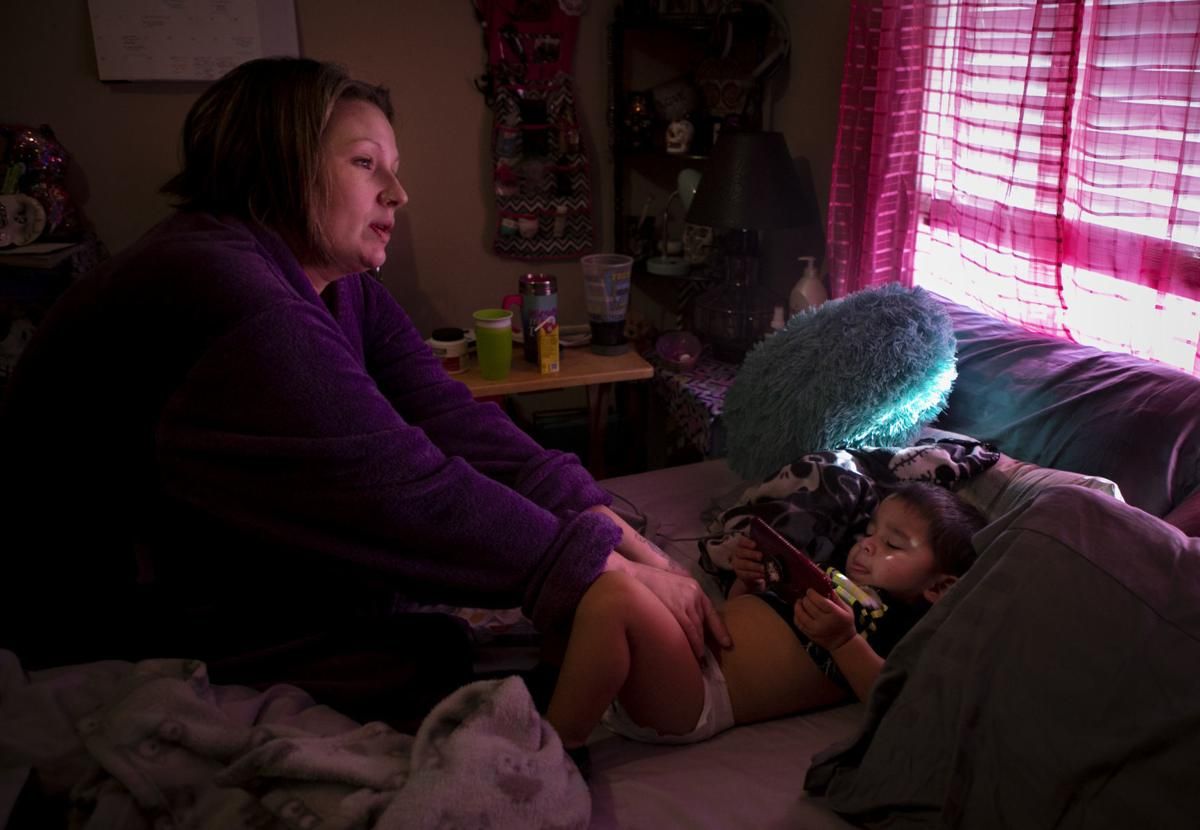 On New Year's Eve 2019, Tera Crowde changes her youngest son's diaper. Jadiyan, 2, was born while Tera was incarcerated. "I had him with my ankle cuffed to the bed while a Riverside correctional officer watched. I got to hold him for two days," she said. Crowder touched her son again, for only the second time, when they were reunited in November 2019.  Image by Julia Rendleman. United States, 2019.