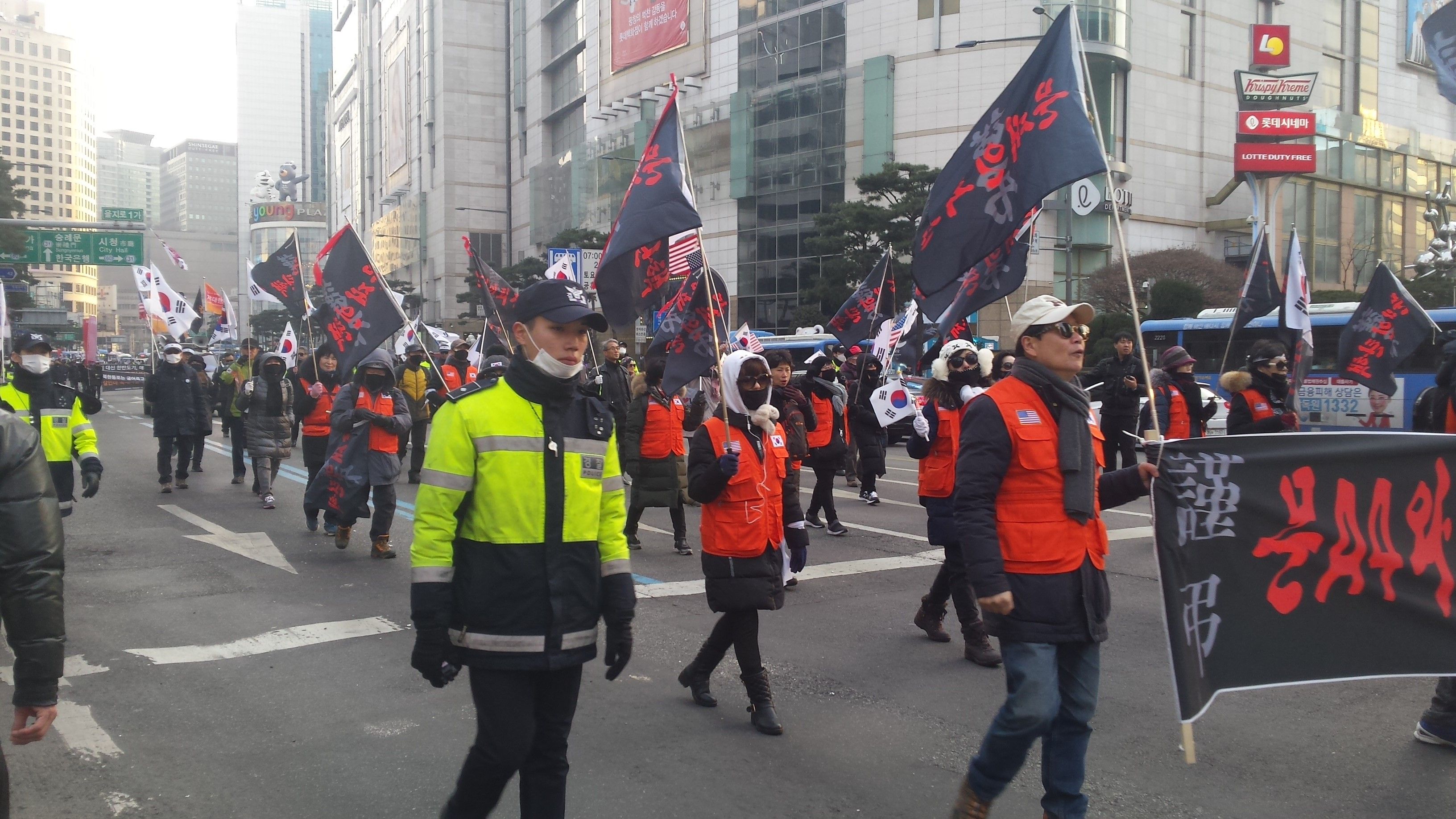 South Korean conservatives march through the streets of downtown Seoul in February in protest of their liberal president's diplomatic outreach to North Korea. Image by Rachel Oswald. South Korea, 2018.
