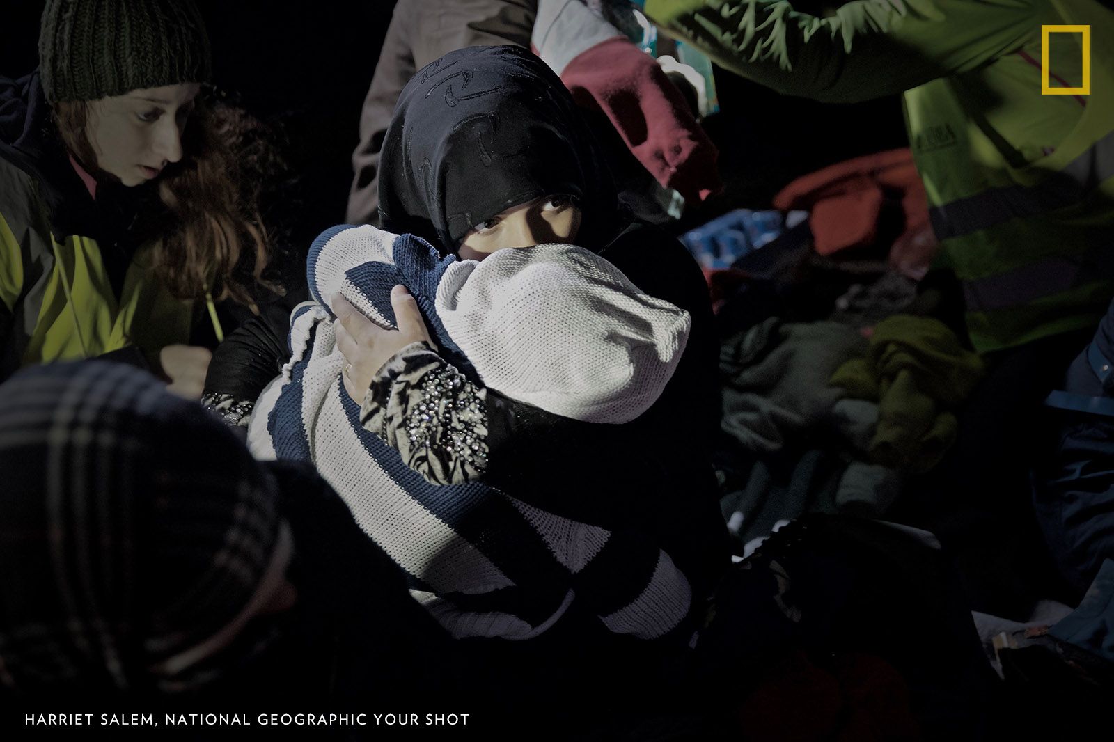 A Syrian woman cradles her crying baby on the shores of Lesbos after more than six hours at sea in a flimsy rubber dinghy.The image reminds me of the lines from Warren Shire’s poem Home: ‘You have to understand, no one puts their children in a boat unless the water is safer than the land.’ Image by Harriet Salem. Greece.