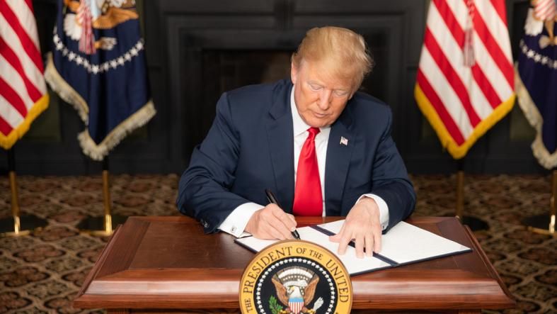President Donald J. Trump signs an Executive Order in Bedminster, New Jersey, entitled “Reimposing Certain Sanctions with Respect to Iran.” Image courtesy of the White House.