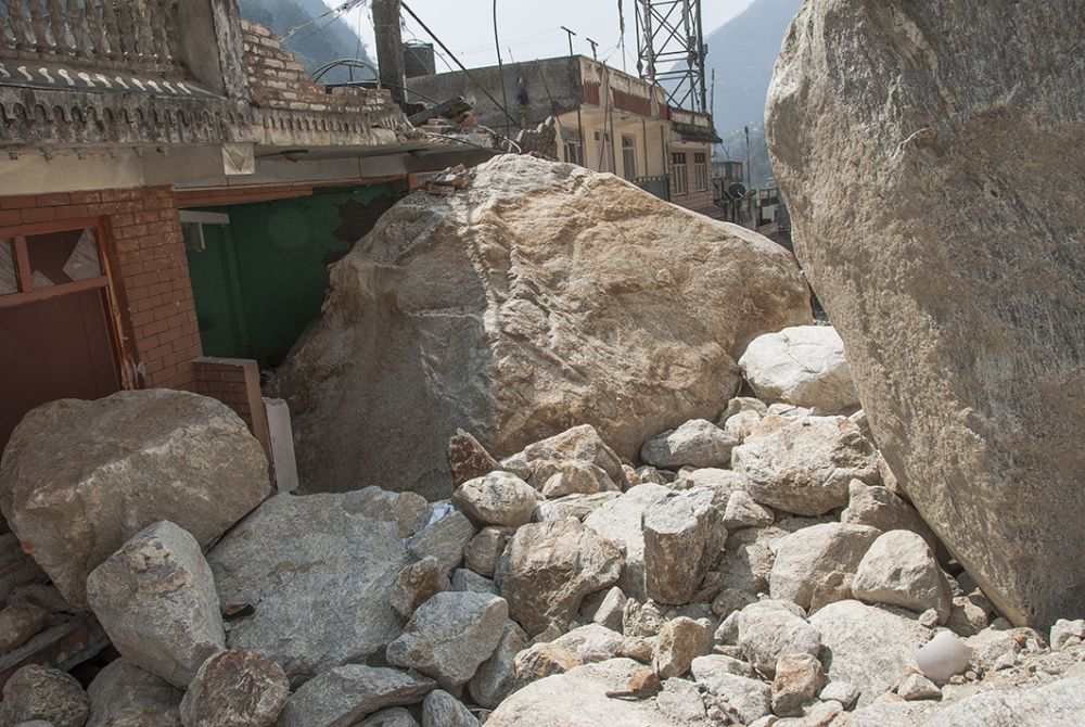 Houses in Kodari in northern Nepal survived the shaking but were crushed by gigantic rock falls. Image courtesy of Jane Qiu. 