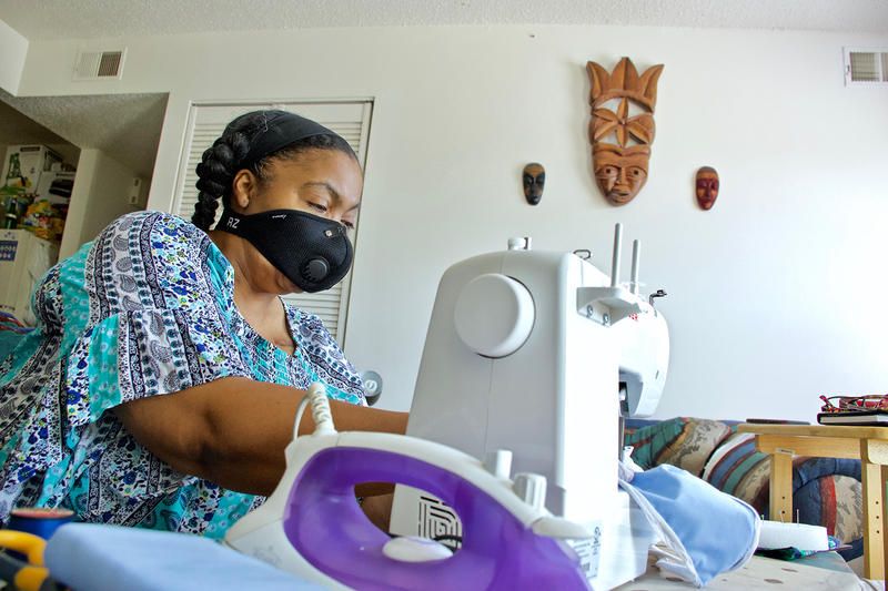 Kim Daniel makes her own masks for her protection at her home in Preservation Square. Image by Wiley Price / St. Louis American. United States, 2020.