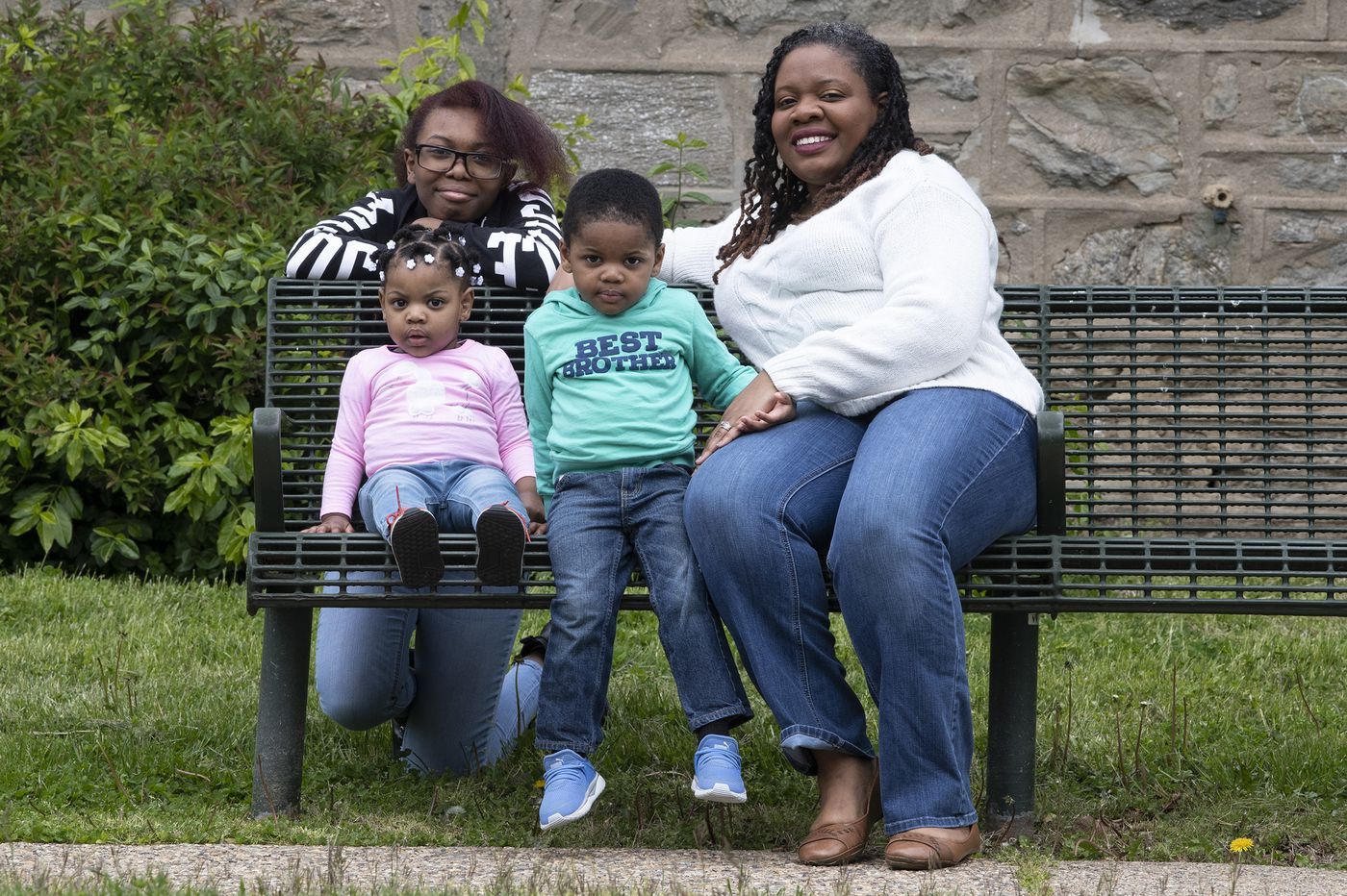 Kyana Hopkins-Thomas, right, is photographed with her kids, Imani Thomas, 15; Imara Thomas, 1; and Keion Thomas, 2, near their home in Philadelphia. Kyana is teacher who is juggling her students' needs with her own children. Image by Jose F. Moreno. United States, 2020.