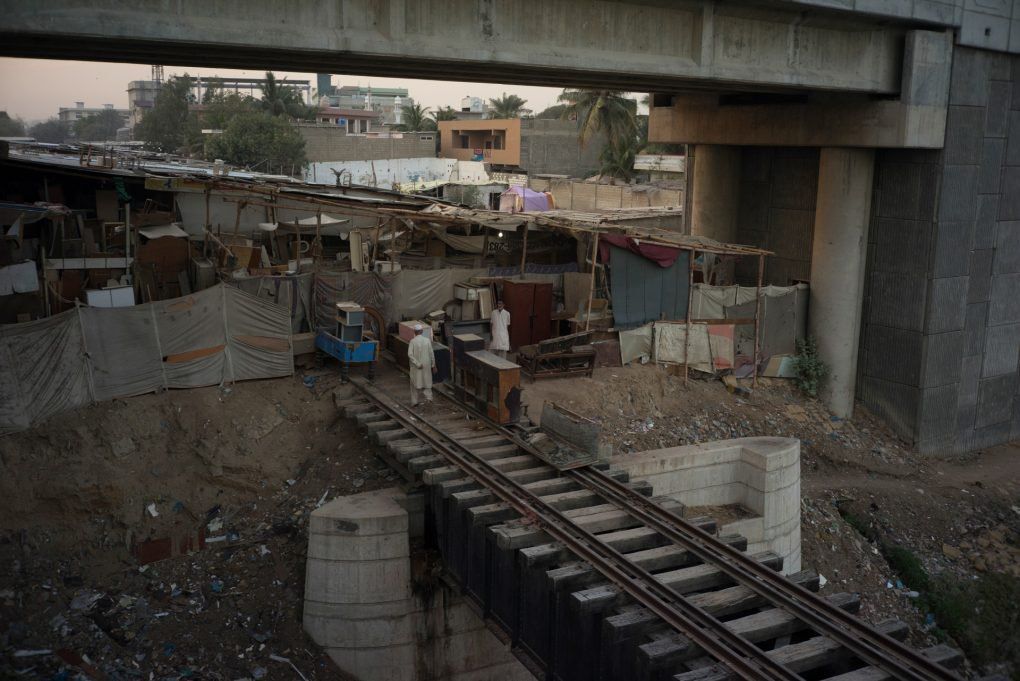Furniture Market on the Tracks near the Lyari River, Karachi, Pakistan. Still image from KCR, 2014-2017, nine-channel multimedia installation. Image by Ivan Sigal. Pakistan, 2017.