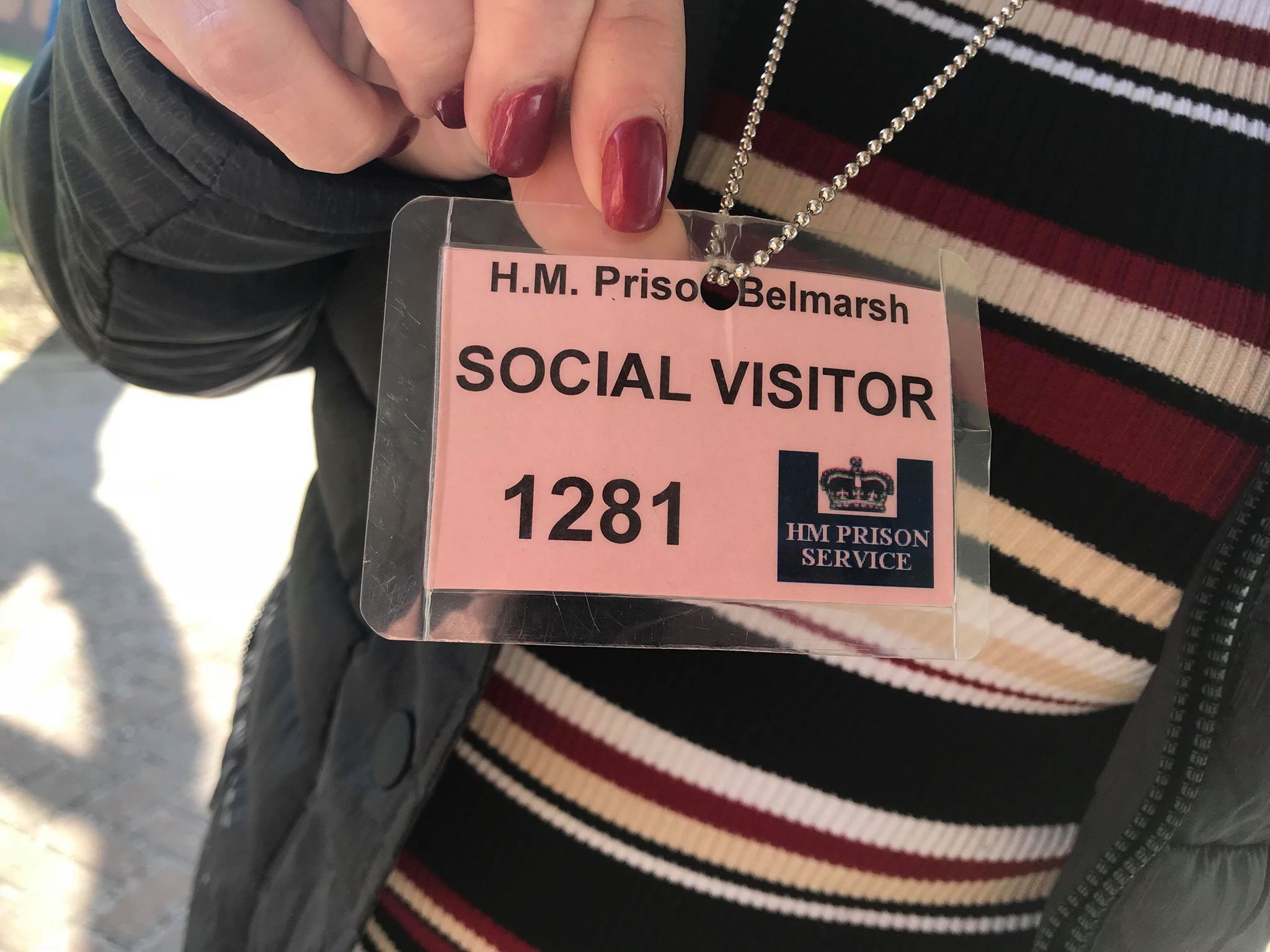 Before being searched for prison contraband, visitors to H.M.P Belmarsh are given a "social visitor" tag. Image by Paul LeBlanc. United Kingdom, 2018.