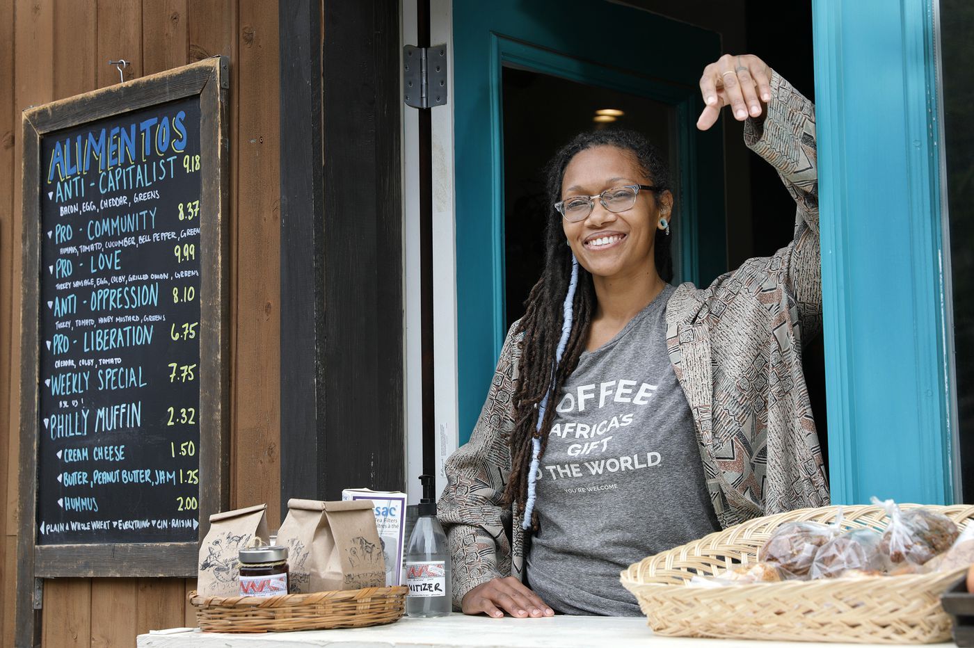 Blew Kind, owner of Franny Lou’s Porch Cafe & Community Space, 2400 Coral St., Phila. Pa., was photographed at the cafe’s take out window on May 8, 2020. Image by Elizabeth Robertson / The Philadelphia Inquirer. United States, 2020.