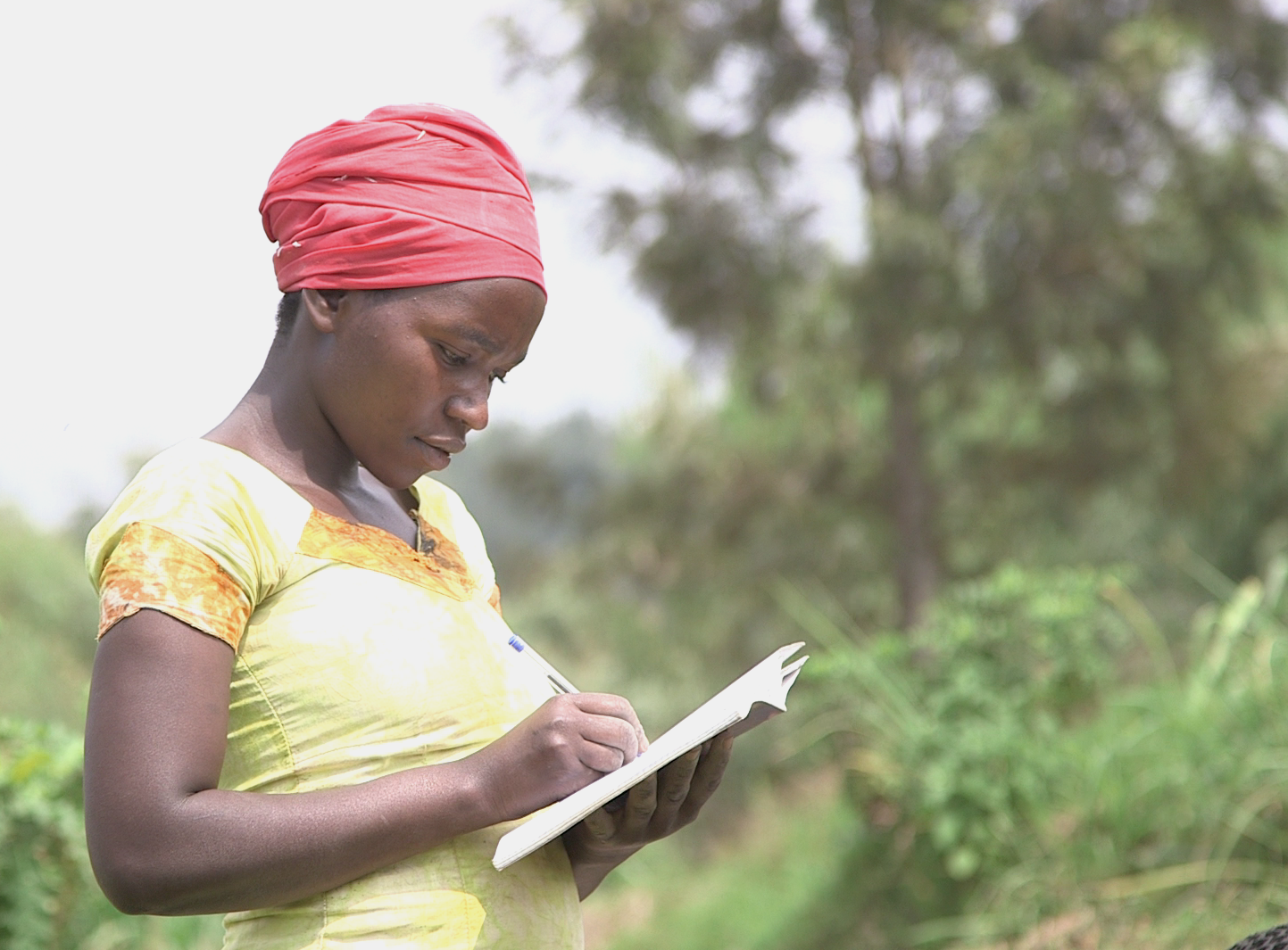 In Rwanda, women are becoming leaders in what were once male-dominated professions. Here Jacqueline Mukamunana, secretary of the Duteraninkunga cassava cooperative, takes attendance. Image by Cammie Behnke. Rwanda, 2018.