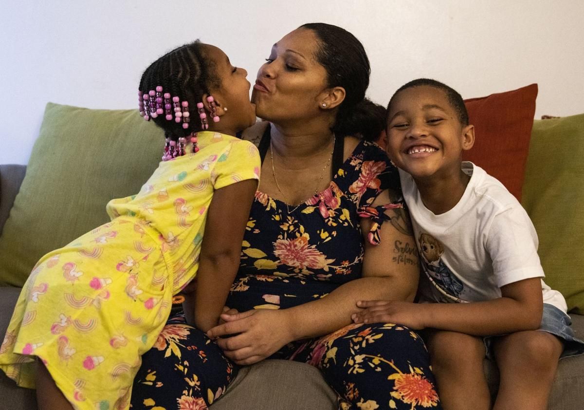 Tyra Johnson, who is 31 weeks pregnant, with her children Madison Hundley (left), 4, and Meegale Hundley, 5. Image by Colter Peterson / Post-Dispatch. United States, 2020.