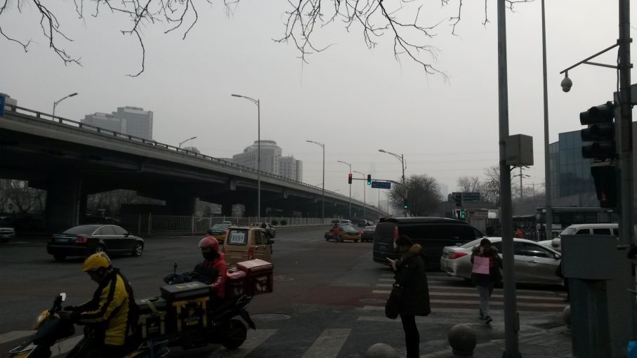 An intersection in Beijing. The pollution that shrouds China’s cities kills an estimated 1.1 million people every year. Image by Beth Gardiner. China, 2017.