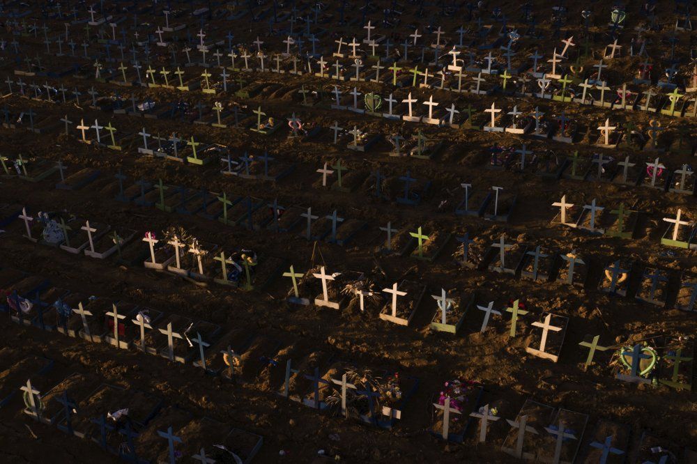 Crosses mark the graves of those who have passed away since early April, filling a new section of the Nossa Senhora Aparecida public cemetery amid the new coronavirus pandemic in Manaus, Brazil, Sunday, May 16, 2020. Image by Felipe Dana / AP Photo. Brazil, 2020.