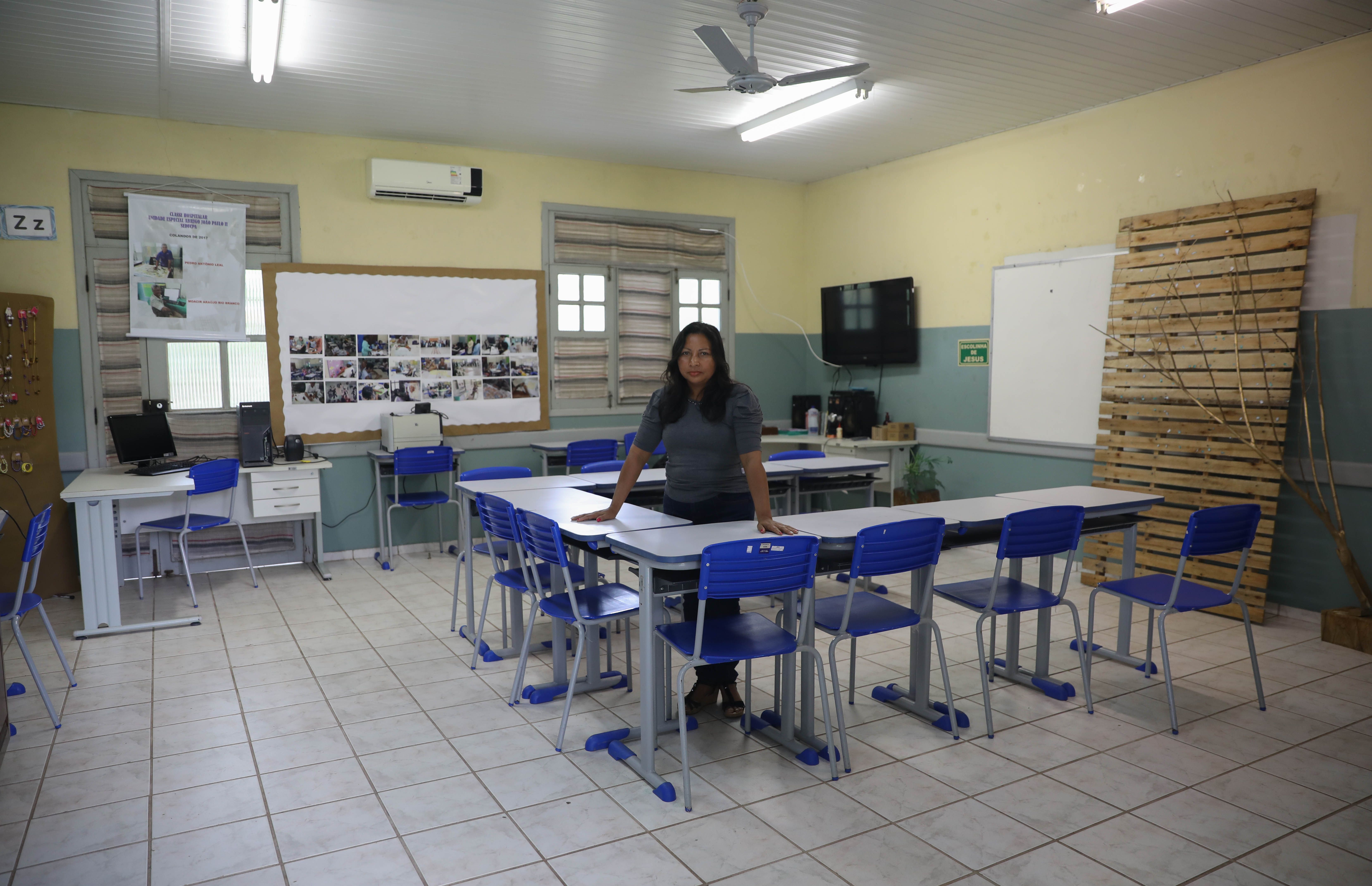 In the midst of summer vacation, Ediana Barbosa stops by her classroom to prepare for the next semester. Image by Anton L. Delgado. Brazil, 2020.