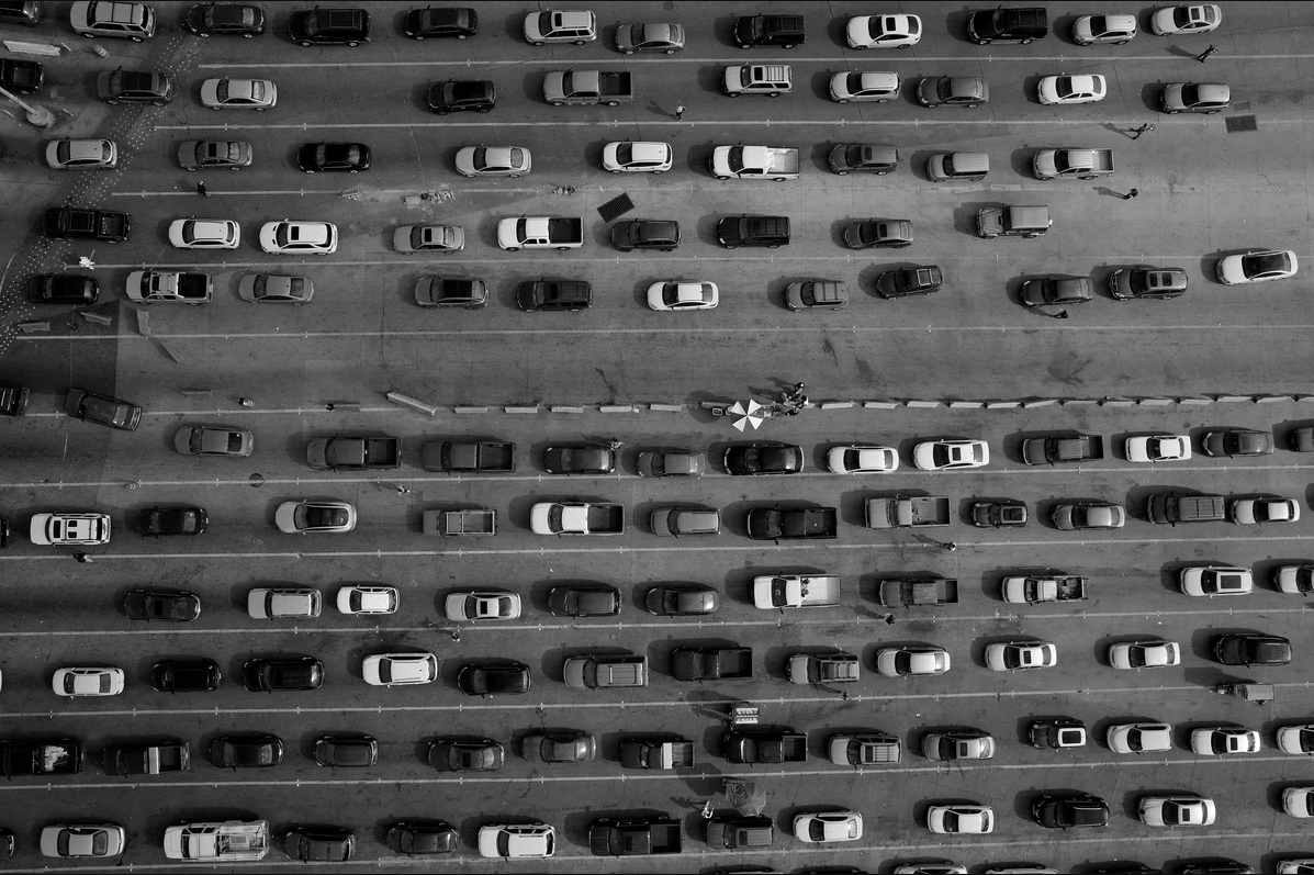 Lanes of cars line up along the U.S.-Mexico border at the port of entry at San Ysidro, California and Tijuana, Baja California. The port is the largest land border crossing point in the world. Image by Tomas van Houtryve. United States, 2018.