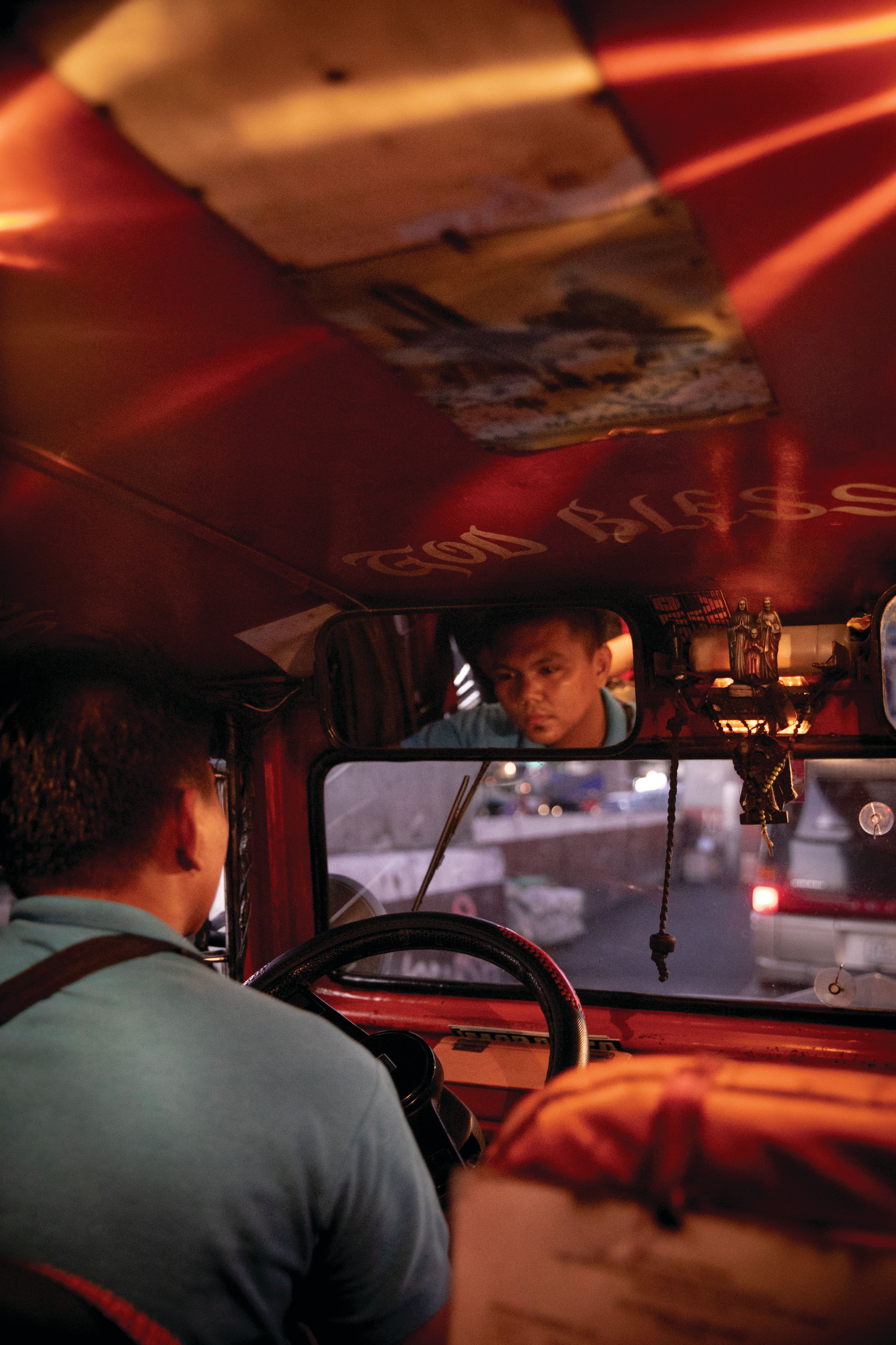 A Jeepney driver transports commuters in the Philippine capital. Image by Eloisa Lopez. Manila, 2019.  