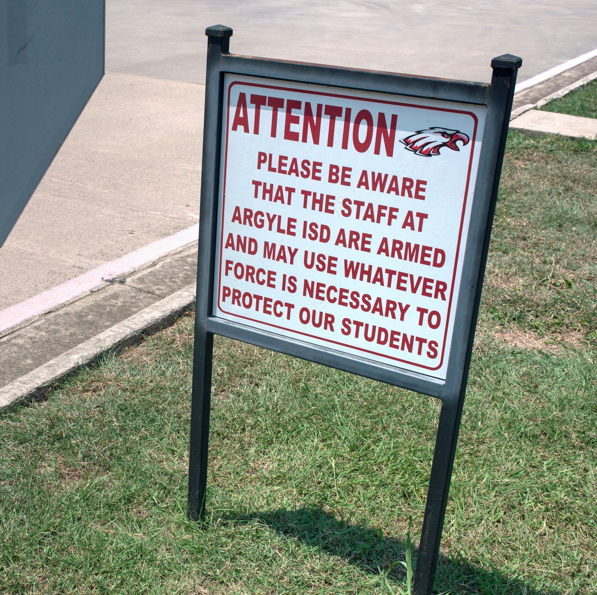 Sign warns that there are armed staff members at Texas school. Image by Spike Johnson. United States, 2018.