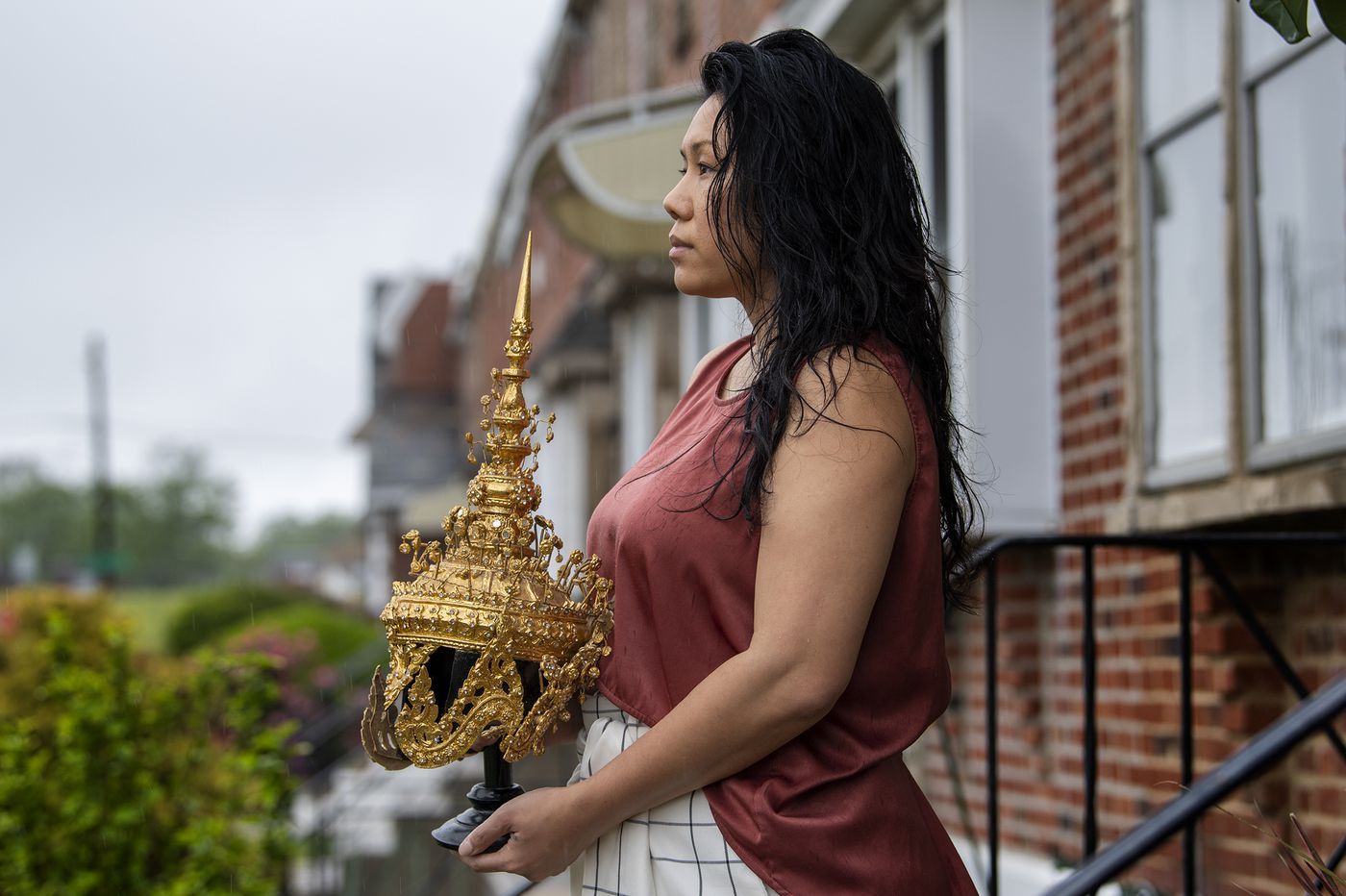 Catzie Vilayphonh is photographed holding a Laos folk crown near her home in Philadelphia, Pa. Friday, May 22, 2020. Vilayphonh is a poet who runs the community arts group Laos in the House. Image by Jose F. Moreno / The Philadelphia Inquirer. United States, 2020.