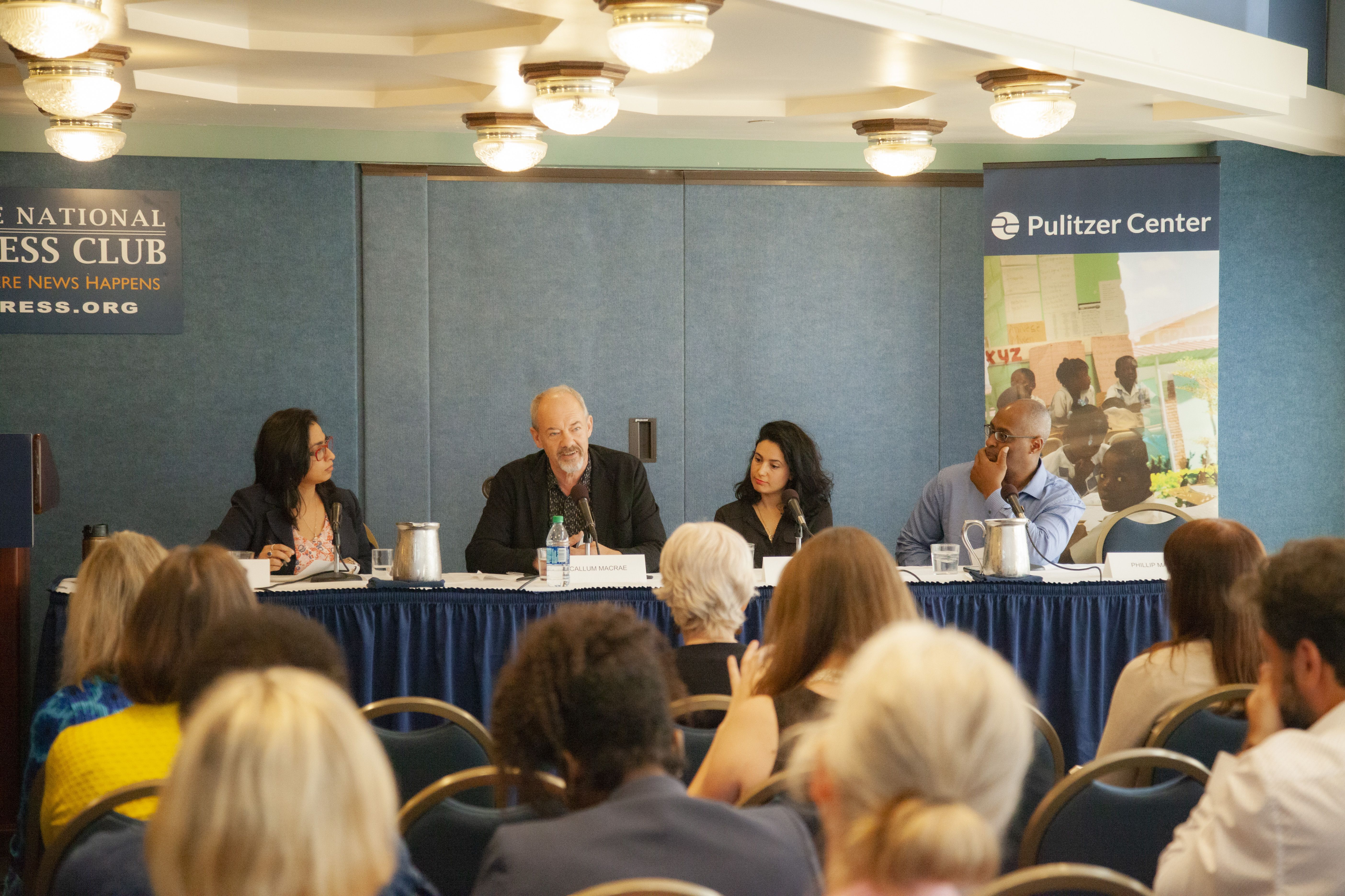 Amber Khan (far left) speaking with Pulitzer Center grantees (from left to right) Callum Macrae, Iris Zaki, and Phillip Martin. Image by Jin Ding. Washington, D.C., 2019.