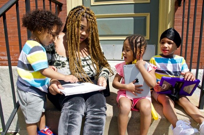 Courtnesha Rogers with her children, (from left) Angelino, 2, Angele and Angelo, both 4. Rogers is eager for them to start school again, but wonders about the measures that will be taken to keep them safe. Image by Wiley Price/St. Louis American. United States, 2020.