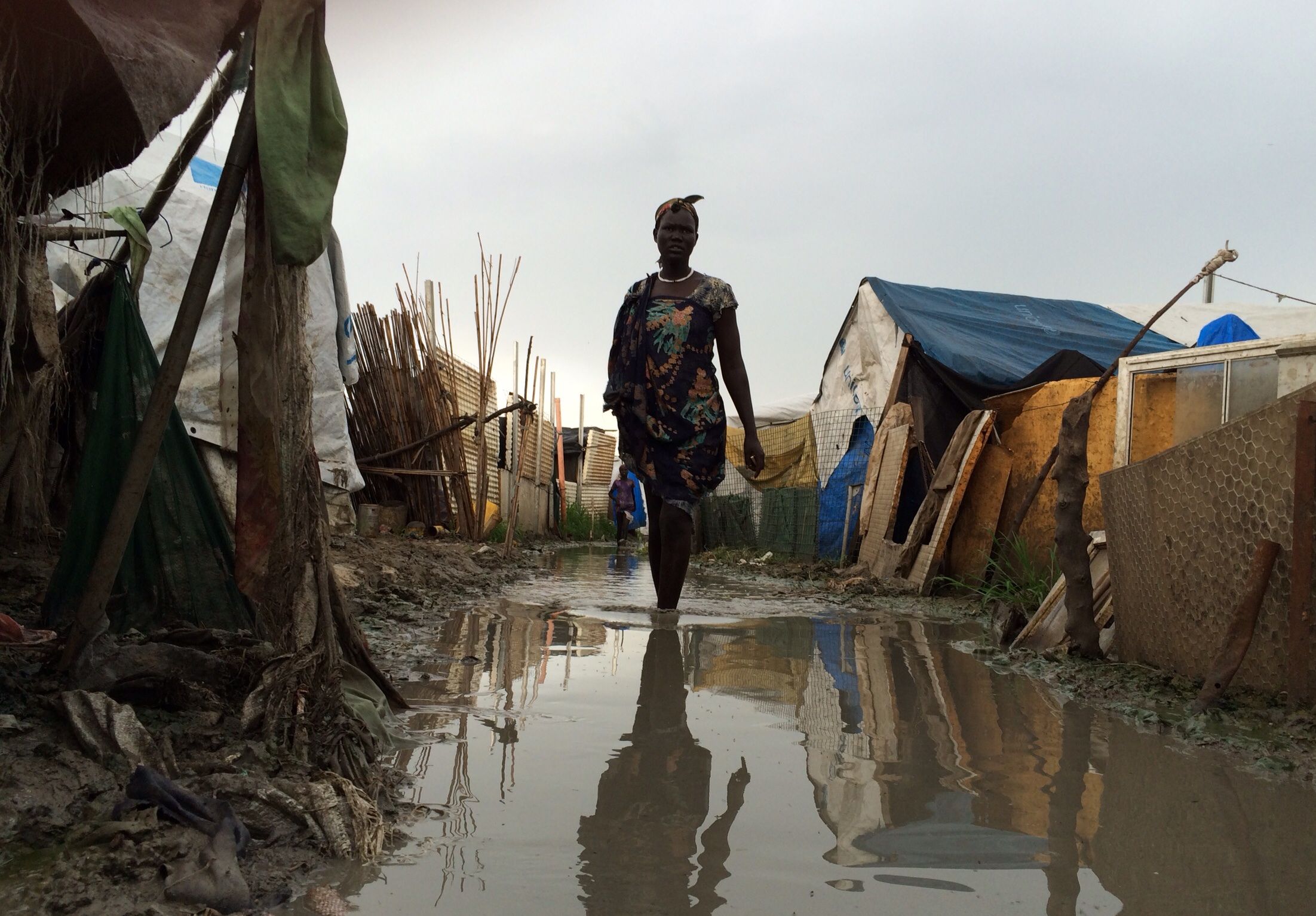 A woman walks through the flooded IDP camp in Malakal, South Sudan. Image by Ty McCormick. South Sudan, 2014.