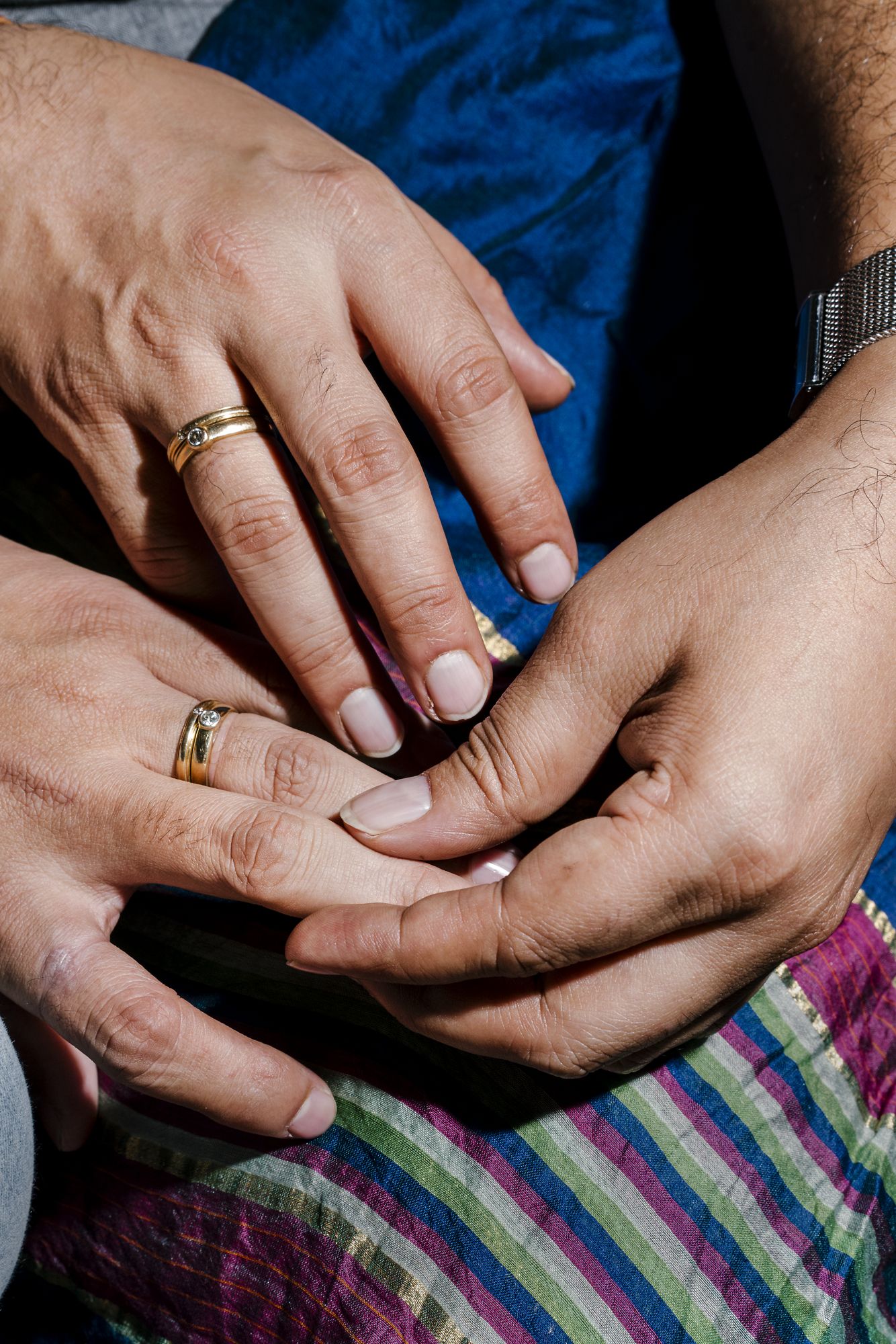 A gay married couple display their wedding rings. They declined to share their names or faces out of fear of how their parents will react when they discover the news. Image by Jake Naughton and Aarti Singh. India, 2018.