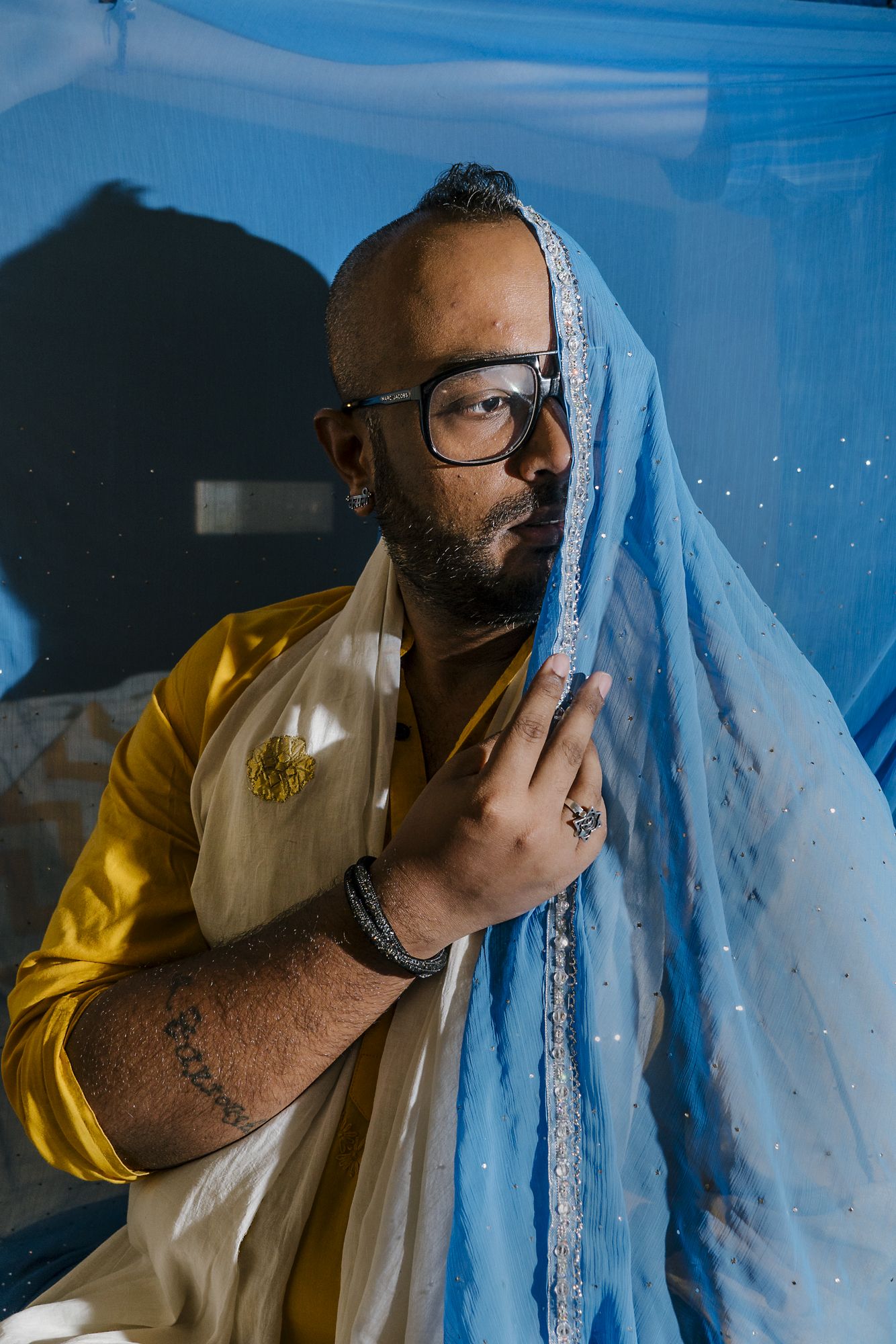 Faraz Arif Ansari, an out gay man and director of “Sisak,” an LGBTQ short film, poses for a portrait in his hotel room in New Delhi. The film tracks a brief encounter between two men who meet each other on Mumbai’s local trains. Image by Jake Naughton and Aarti Singh. India, 2017.