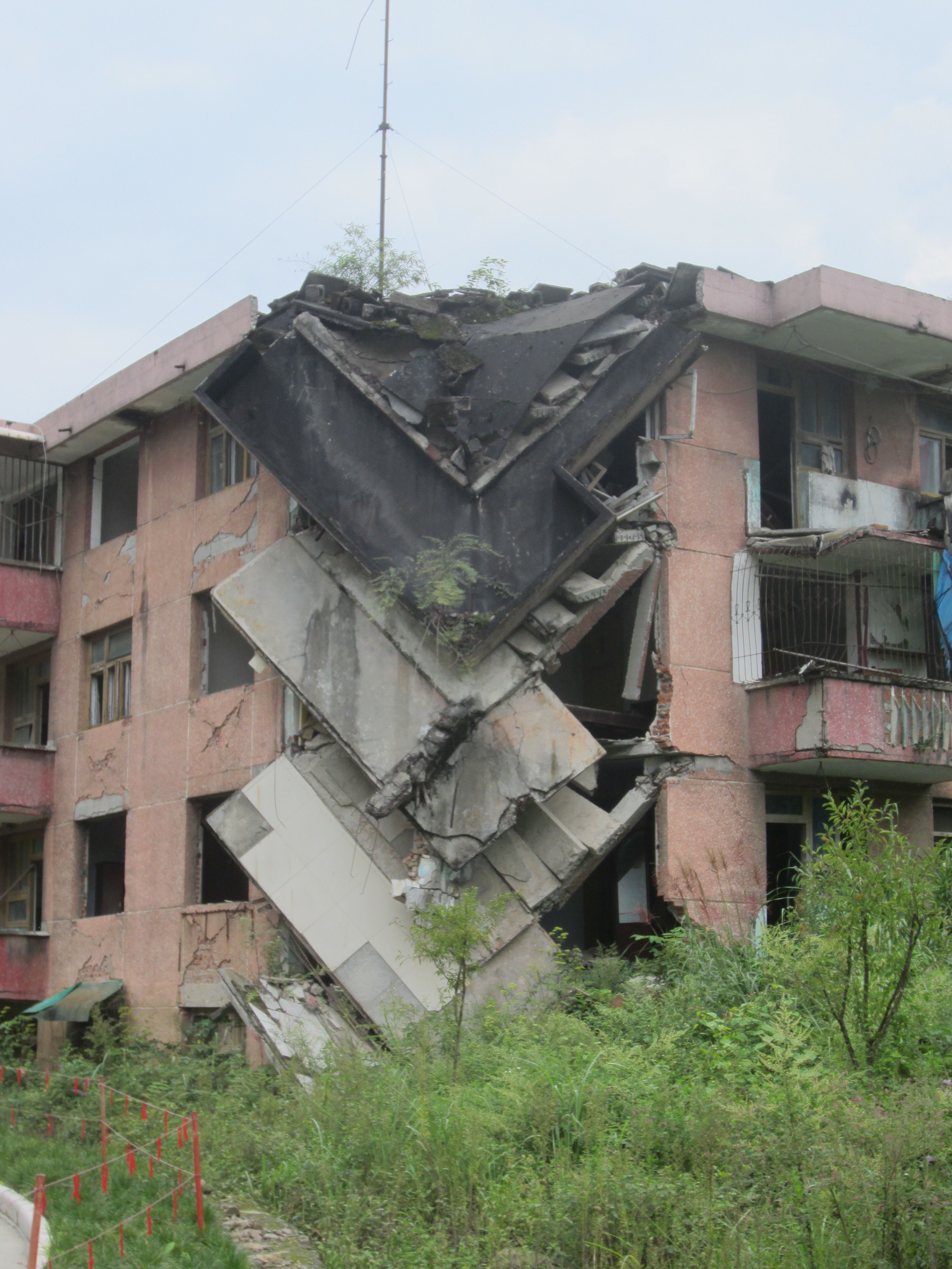 The earthquake was a real-time test of building safety. In this structure, the corner stairwell gave way while the rest of the building remained intact. Image by Daniel Brook. China, 2015.