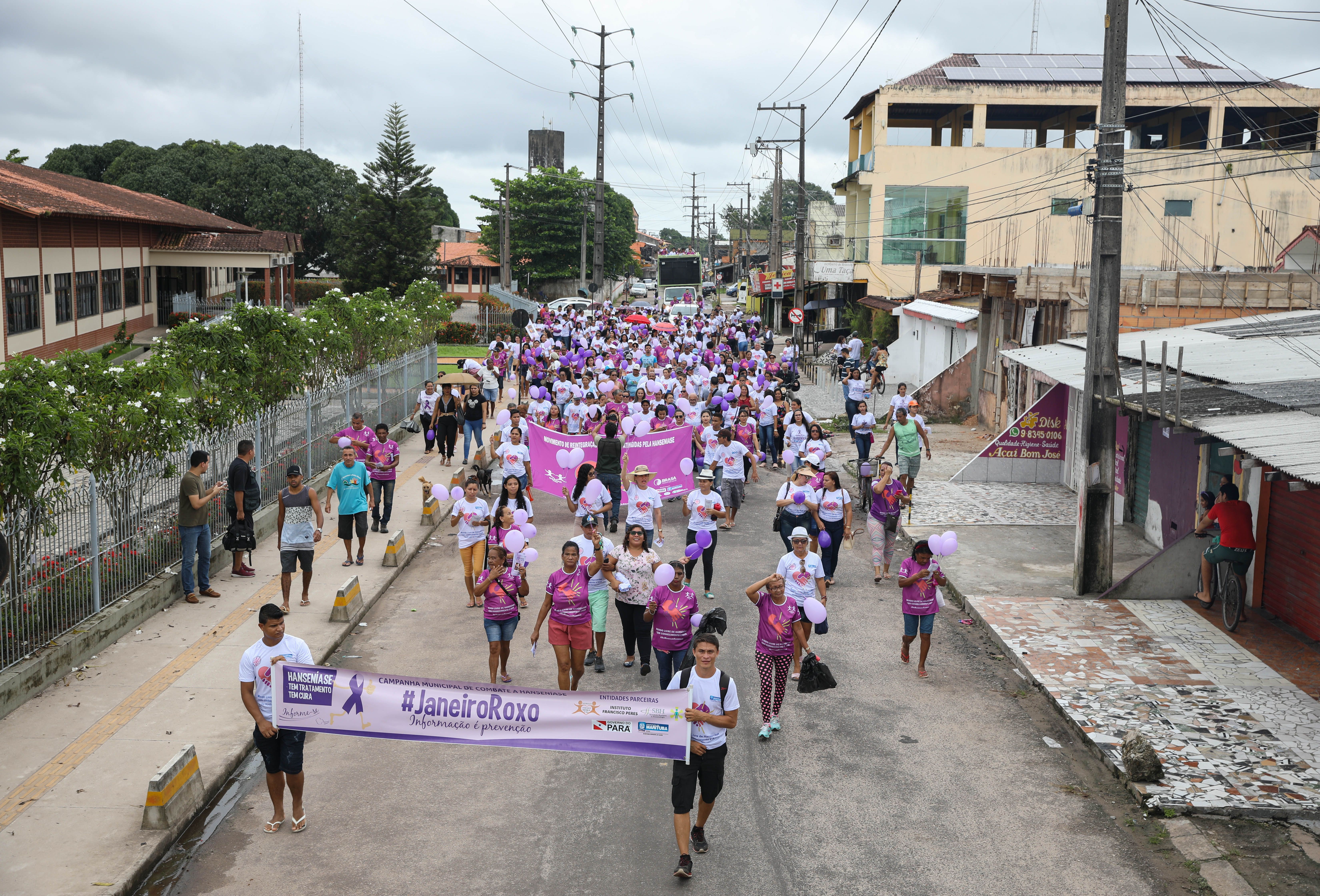 Holding purple posters, waving purple balloons and wearing purple shirts, more than a hundred people participated in a march during “Purple January,” a month-long leprosy awareness campaign. Image by Anton L. Delgado. Brazil, 2020.