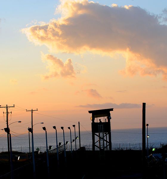 A watchtower at the Guantanamo Bay prison camp, at dusk. Image courtesy of Wikimedia Commons. Cuba, 2011.  