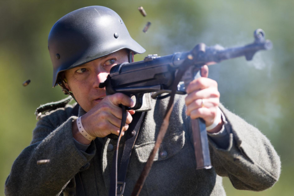 A soldier participates in a field battle during World War II Days on Saturday, Sept. 22, 2018, at Midway Village Museum in Rockford. Image by Scott P. Yates/Rockford Register Star. United States, 2018.