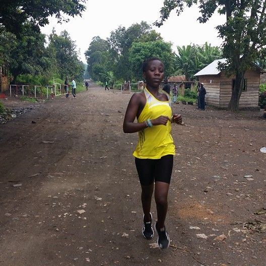 Beatrice Kamuchanga runs down the main road in Kirotshe, Democratic Republic of Congo.