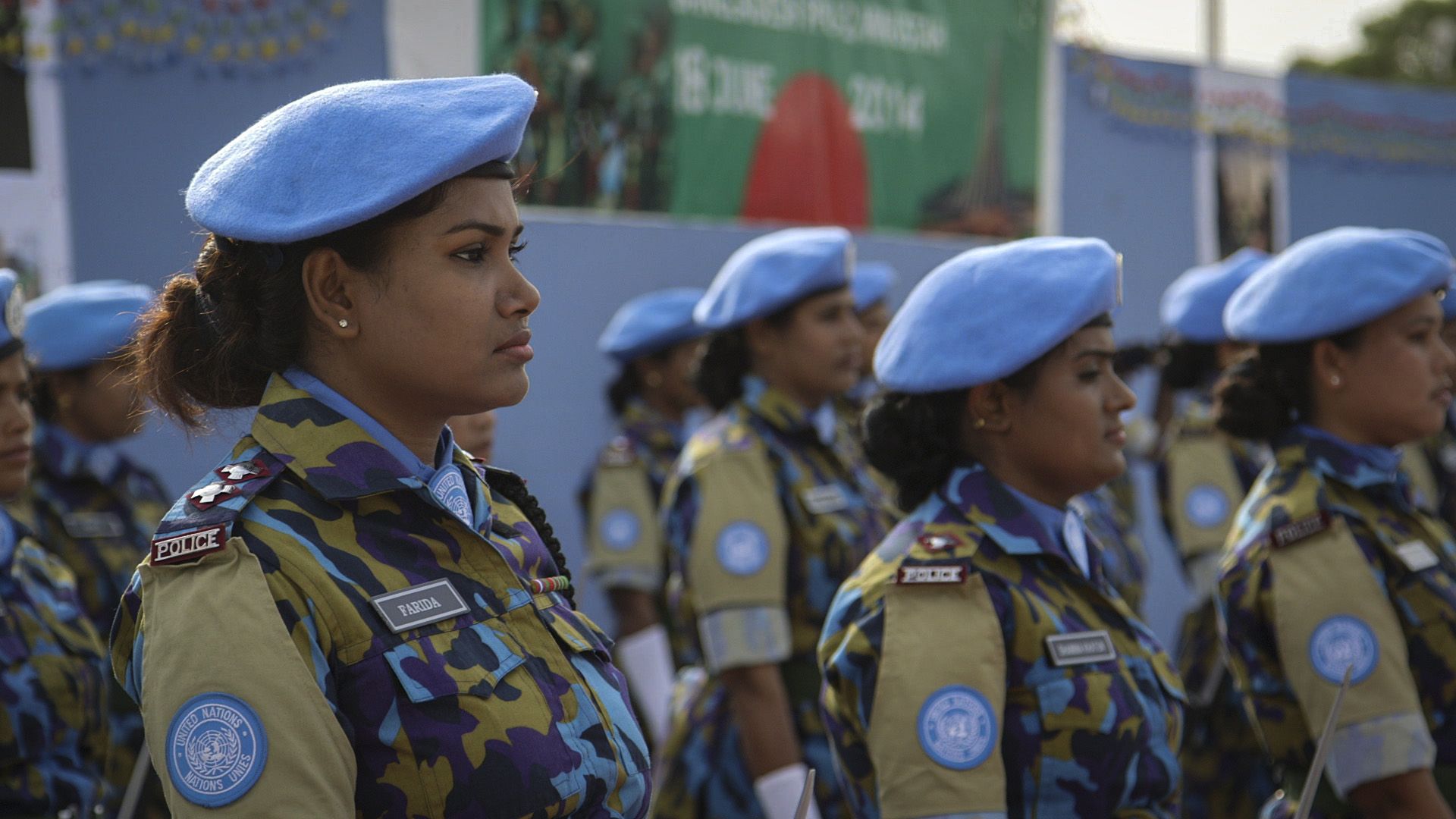 Farida Parveen, a foot soldier from Bangladesh, stands in line. 