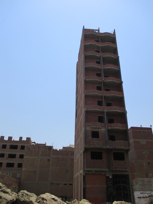 A newly-built apartment block in Kafr. Each floor of a new building is worth several times what a farmer can earn in a year by farming the same amount of land. Image by Jahd Khalil. Egypt, 2017.